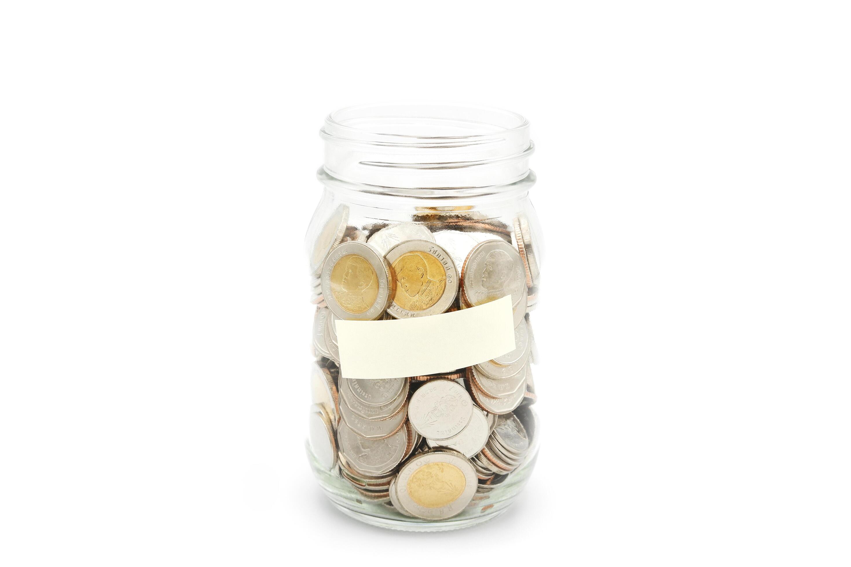 Thai Baht coins in a glass jar. Business and finance concept. Stock Free