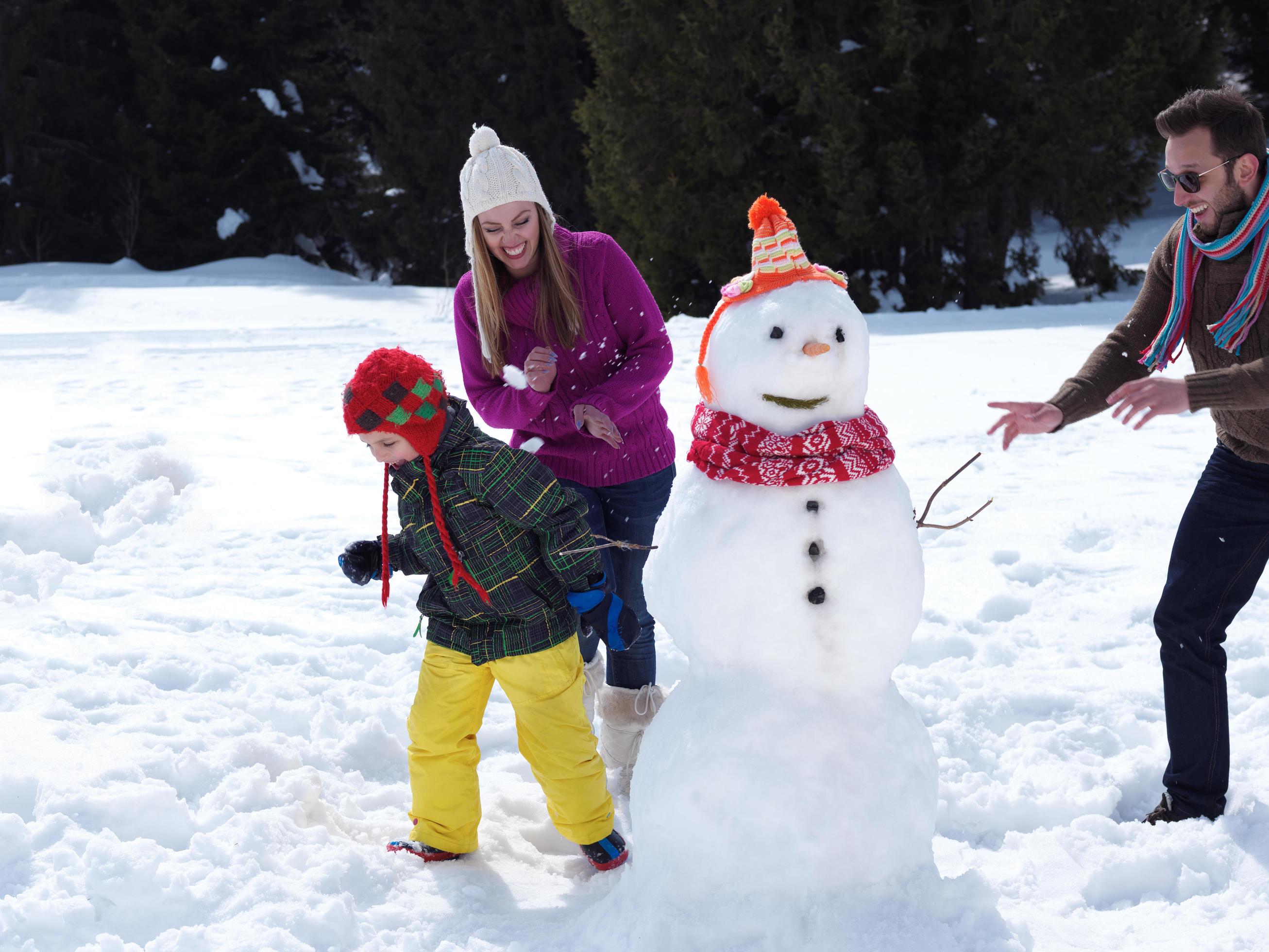 happy family making snowman Stock Free