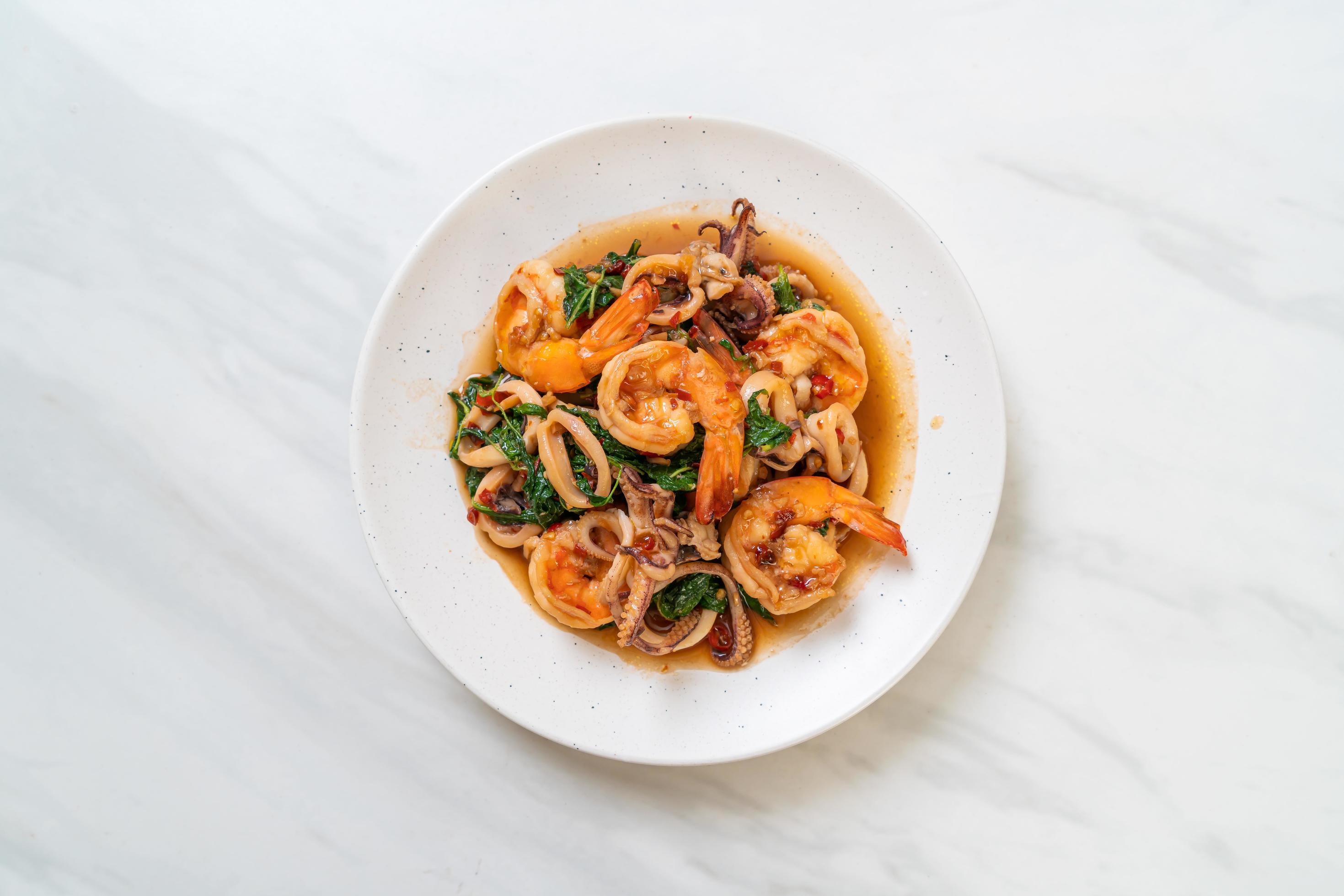 Stir-fried seafood of shrimp and squid with Thai basil – Asian food style Stock Free