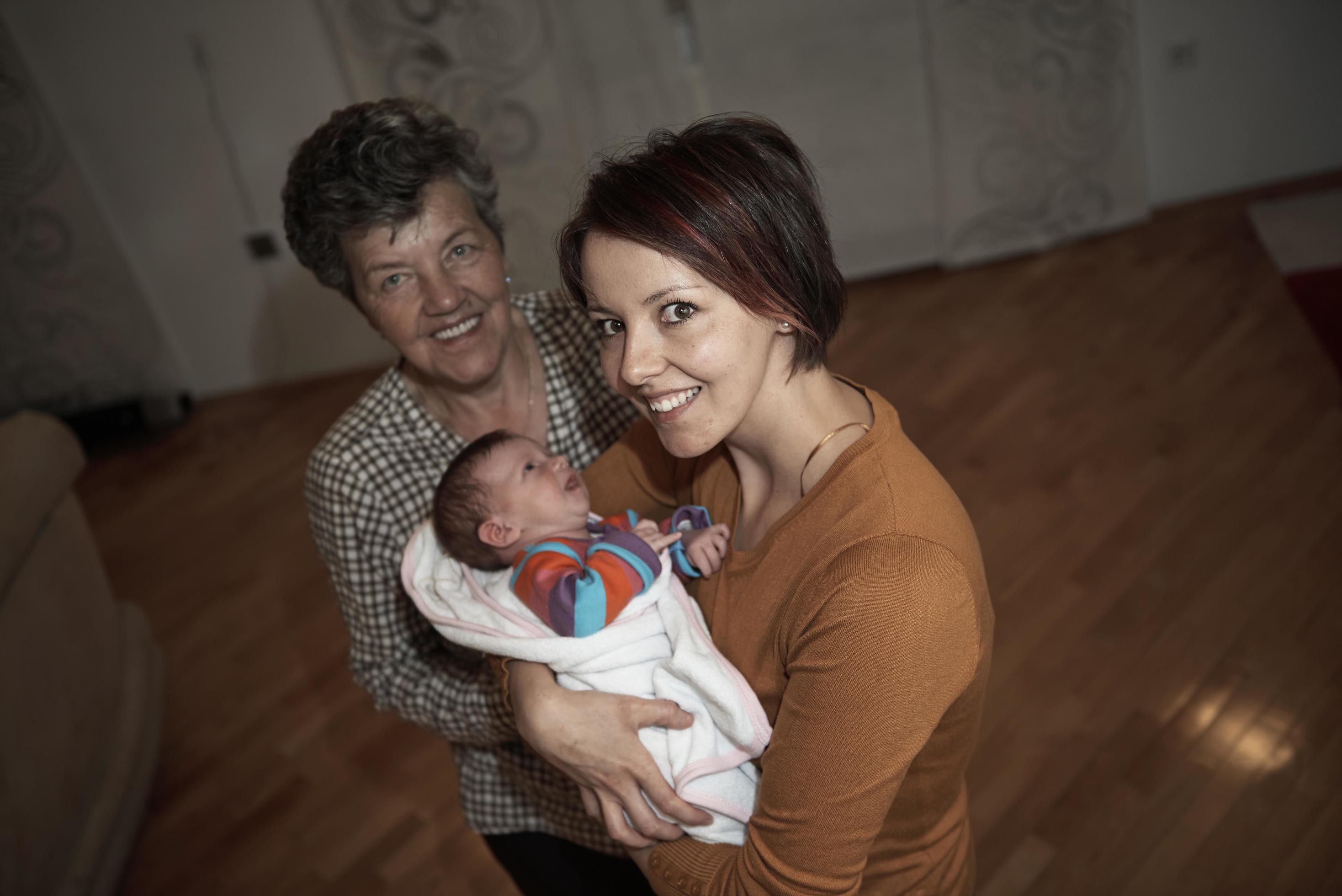 family portrait with grandparents parents and baby Stock Free