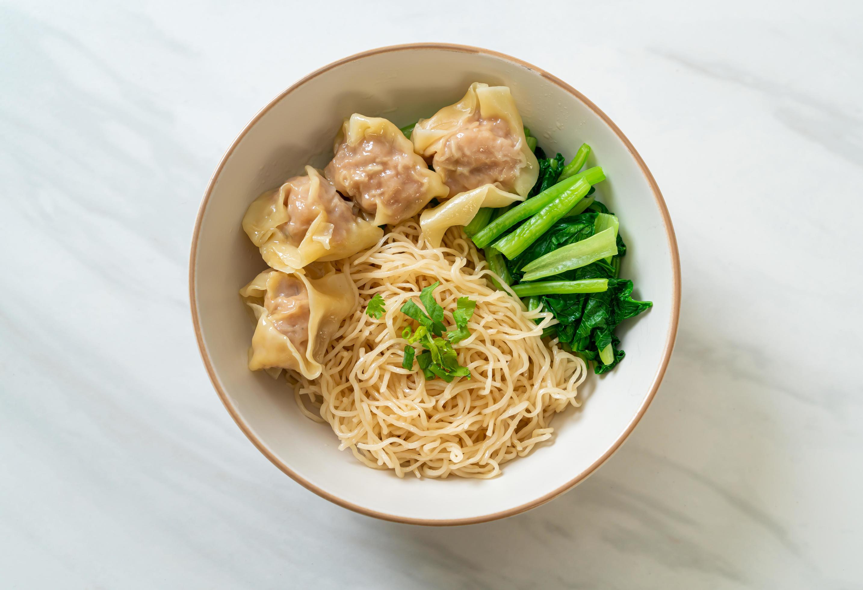 Dried egg noodles with pork wonton or pork dumplings without soup Asian food style Stock Free