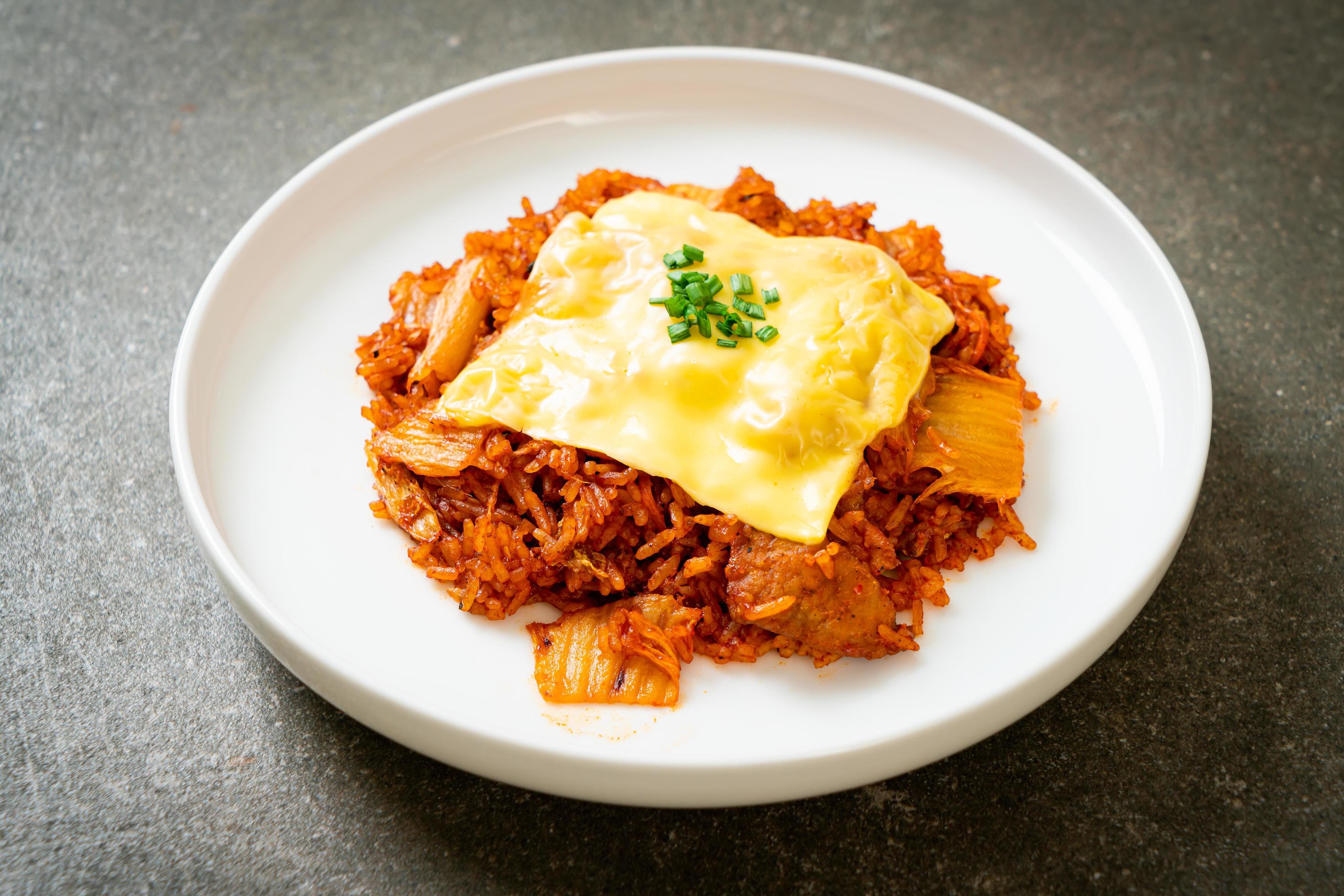 Kimchi fried rice with pork and topped cheese – Asian and fusion food style Stock Free