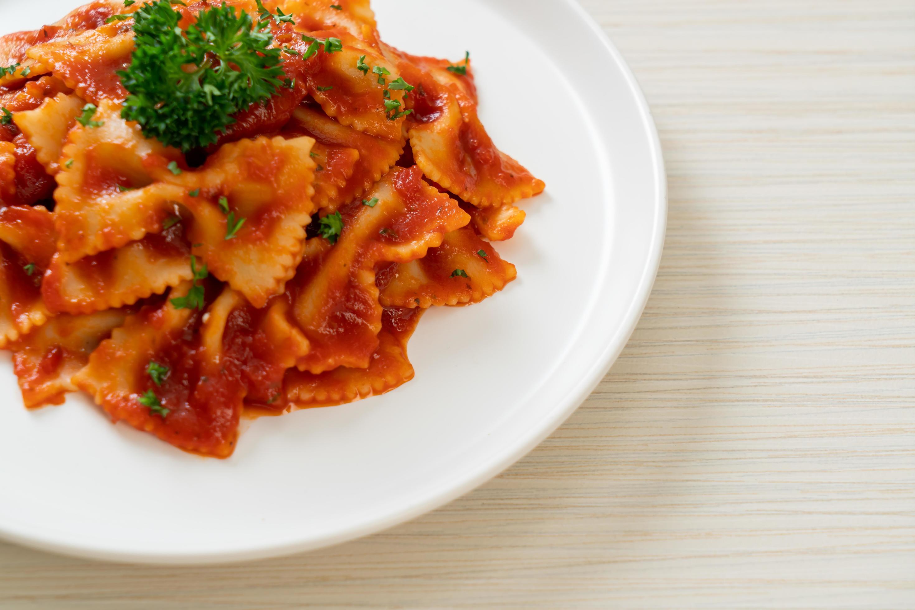 Farfalle pasta in tomato sauce with parsley – Italian food style Stock Free