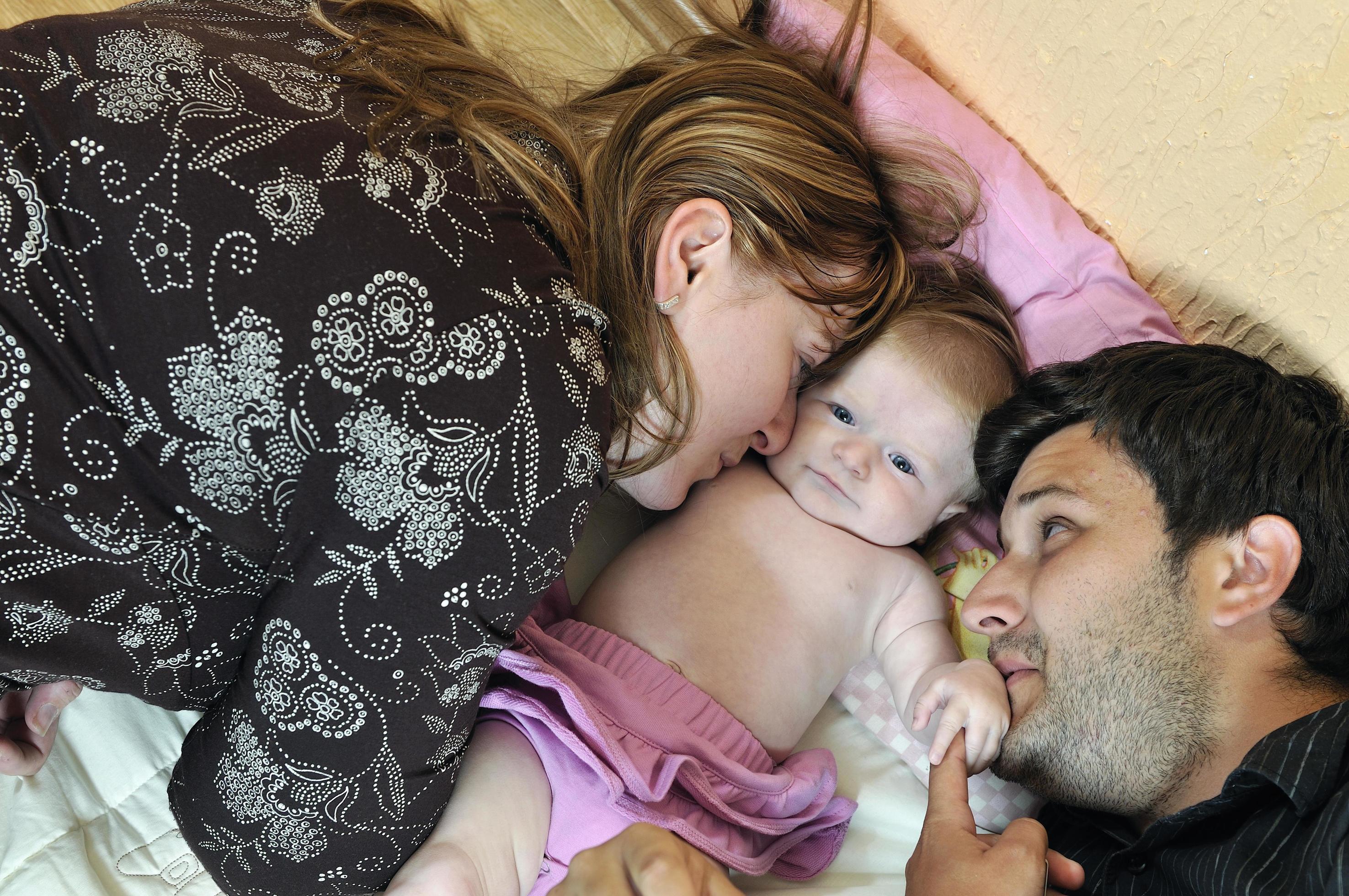 portrait of young family with cute little babby Stock Free