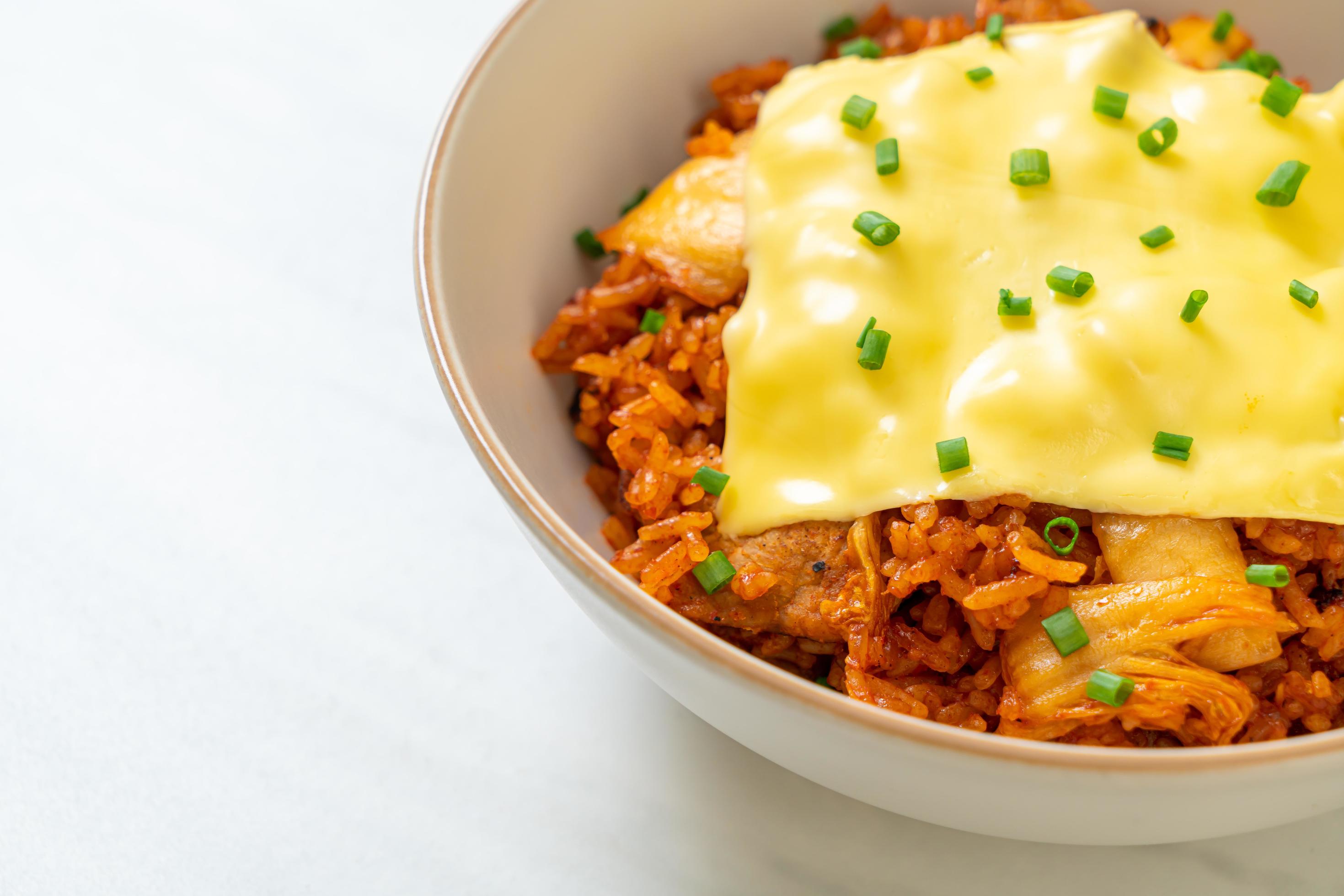 Kimchi fried rice with pork and topped cheese – Asian and fusion food style Stock Free