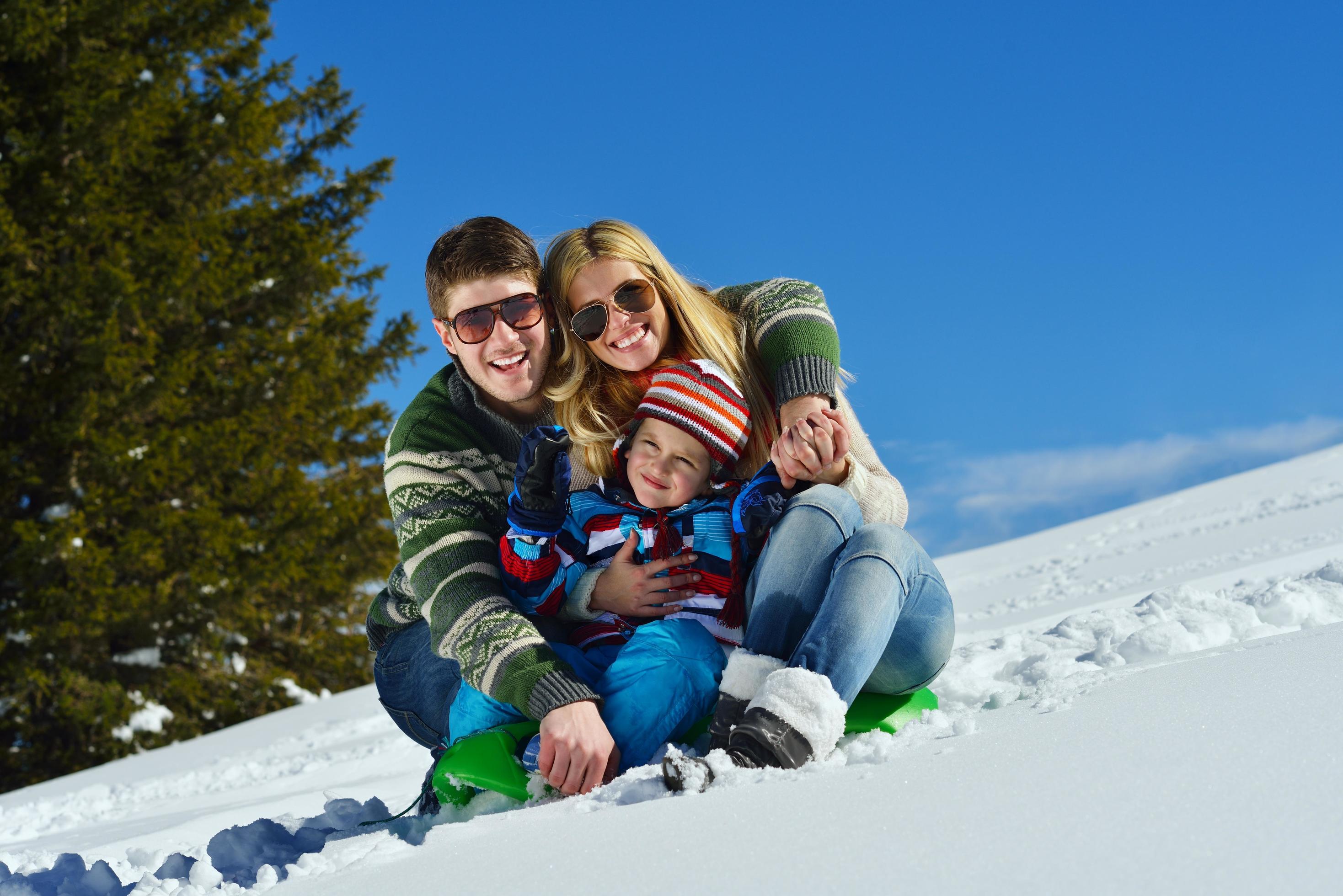 family having fun on fresh snow at winter Stock Free