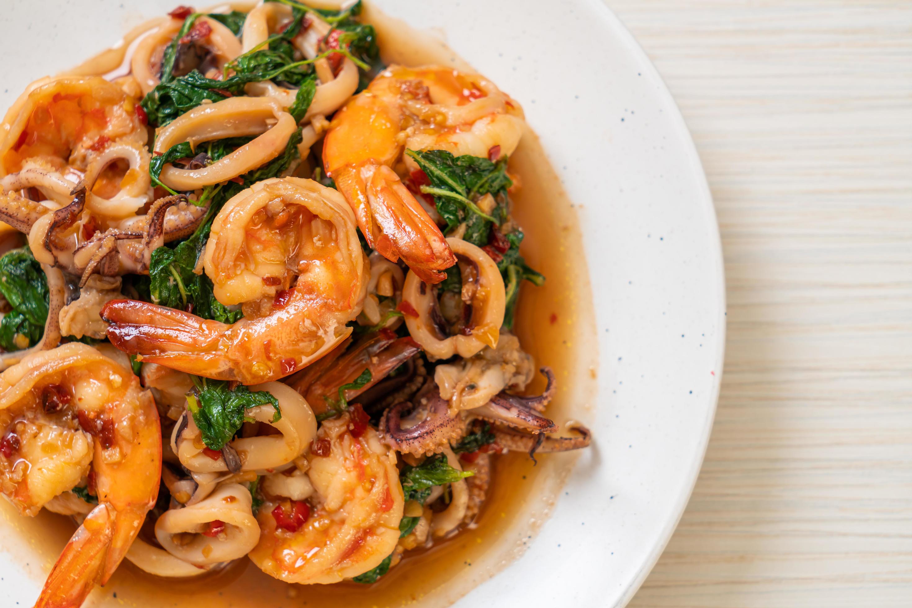 Stir-fried seafood of shrimp and squid with Thai basil – Asian food style Stock Free