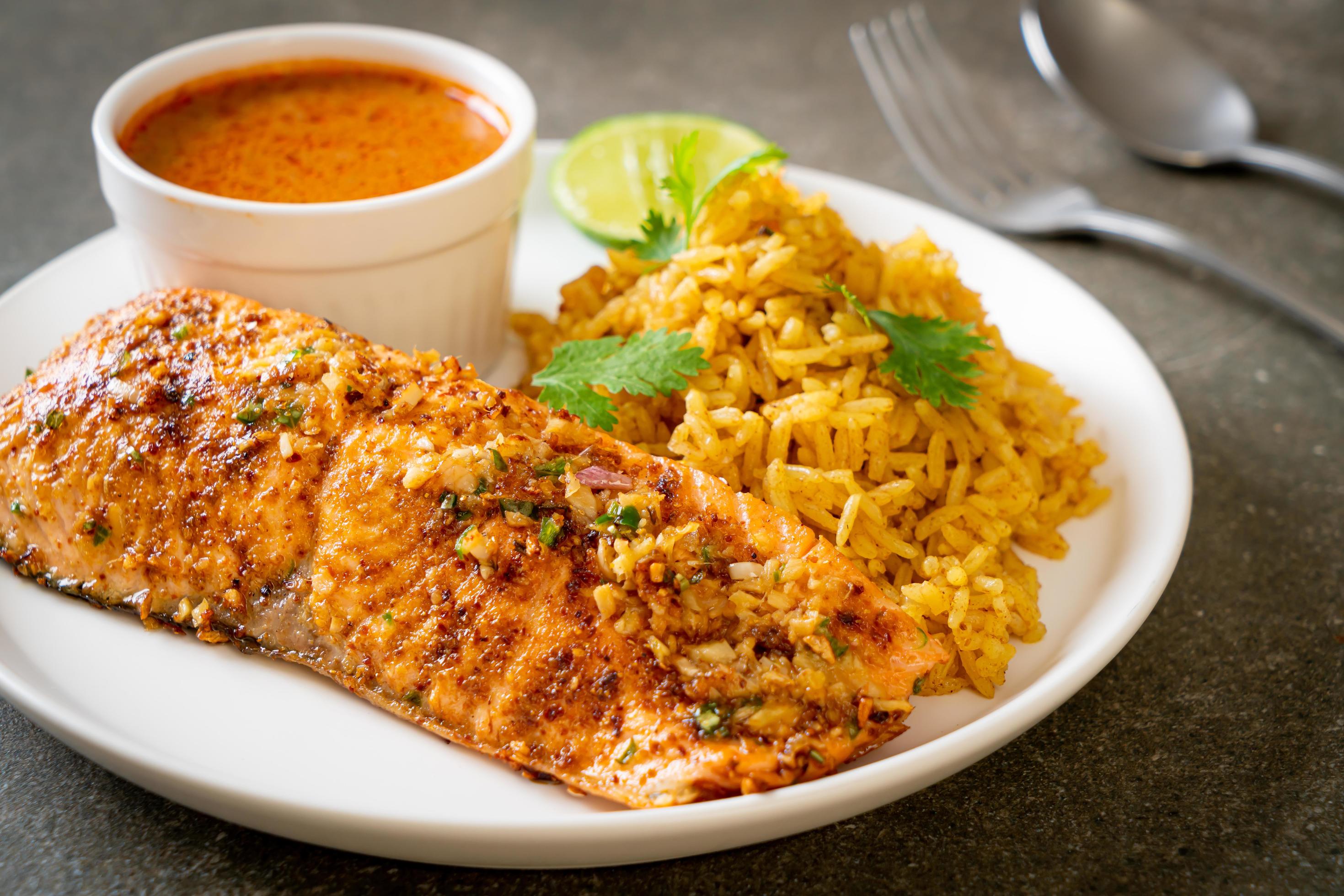 Pan-seared salmon tandoori with masala rice – Muslim food style Stock Free