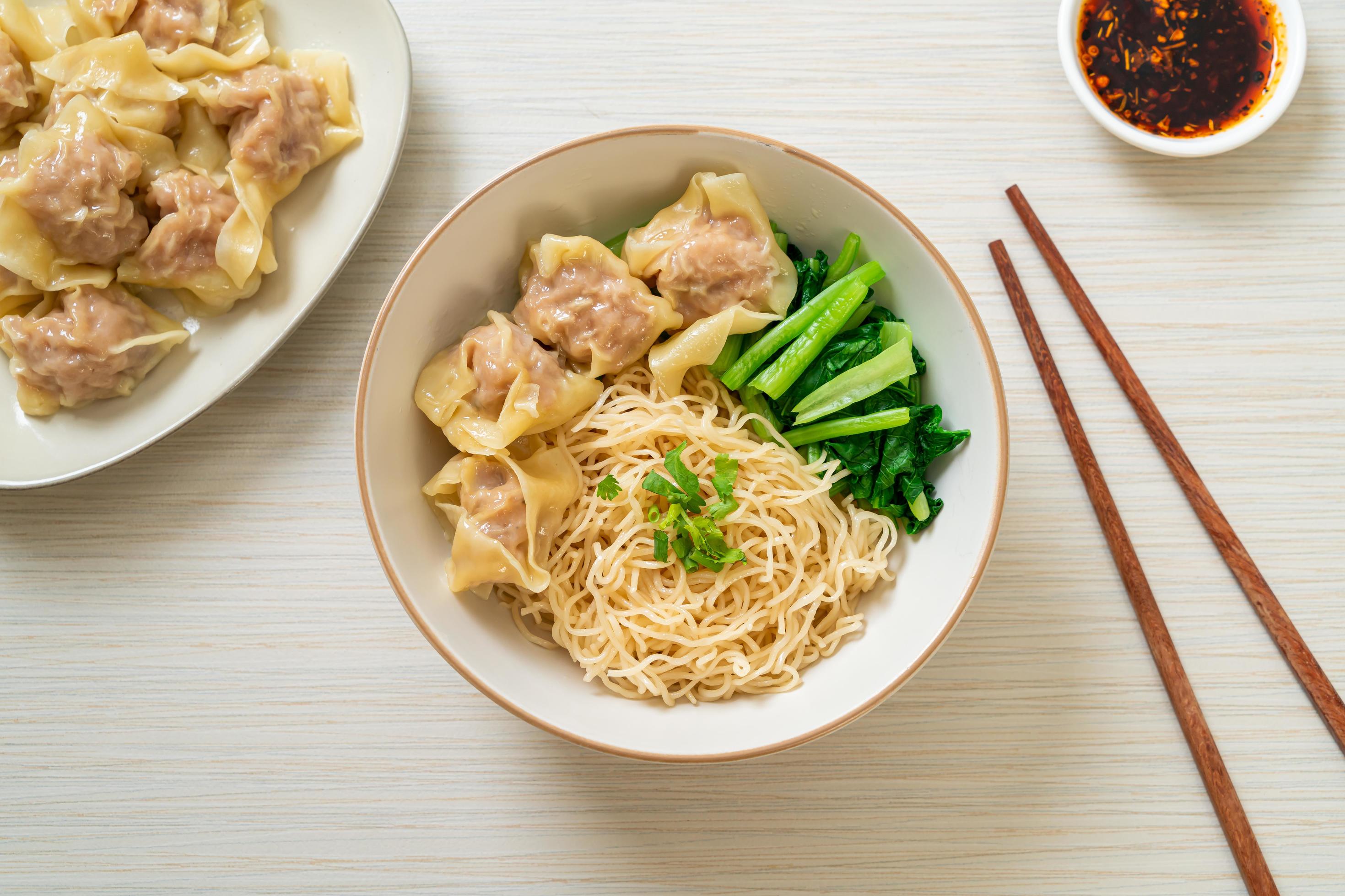 Dried egg noodles with pork wonton or pork dumplings without soup Asian food style Stock Free