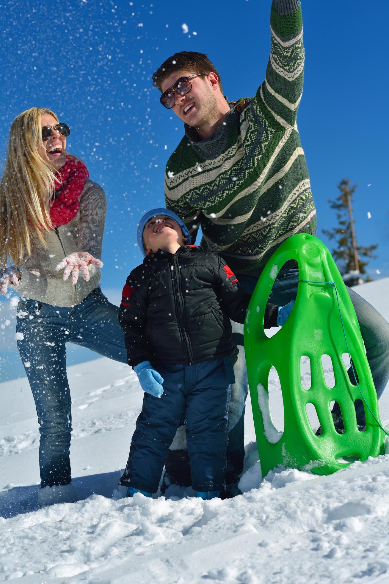 family having fun on fresh snow at winter Stock Free