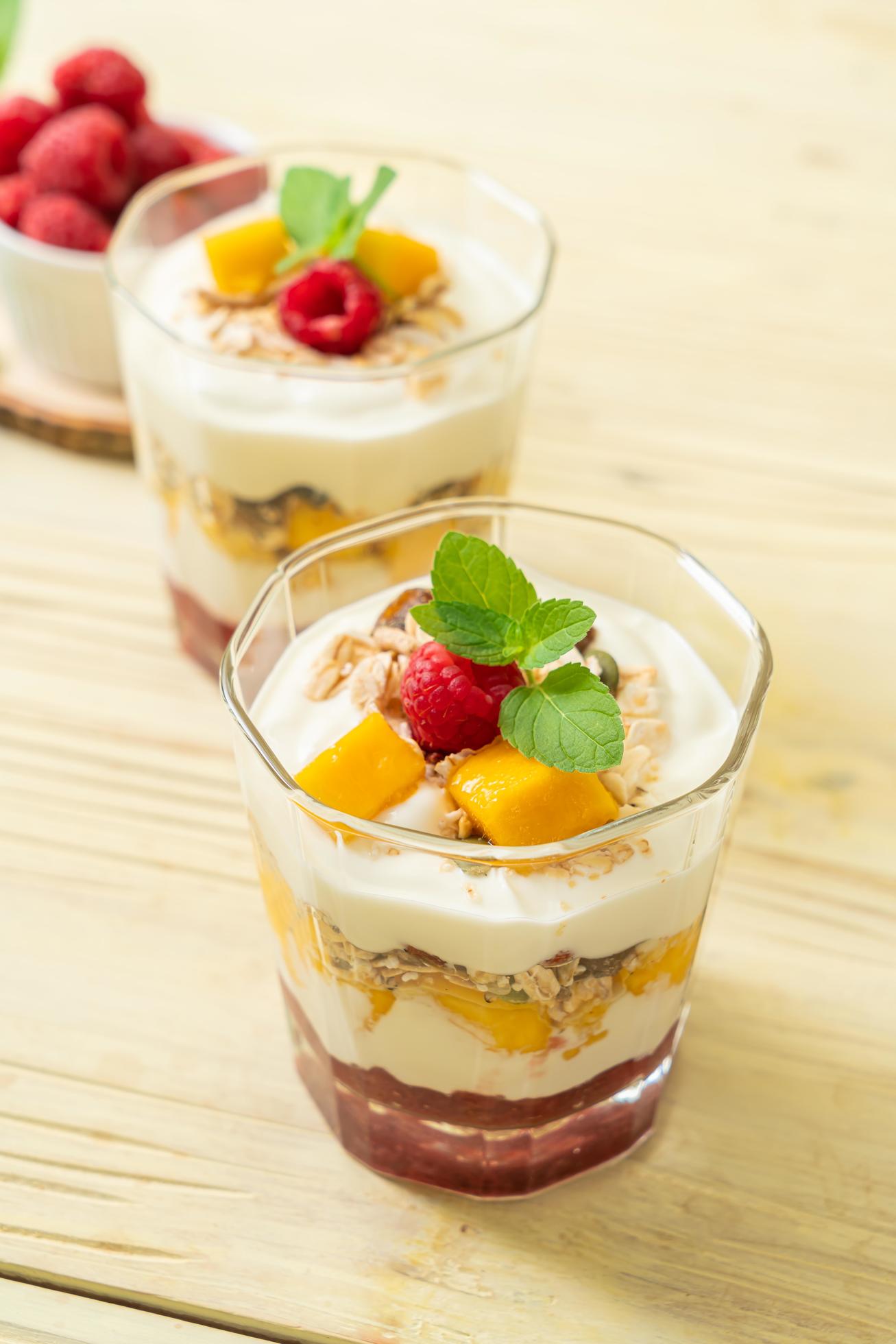 Homemade fresh mango and fresh raspberry with yogurt and granola – healthy food style Stock Free