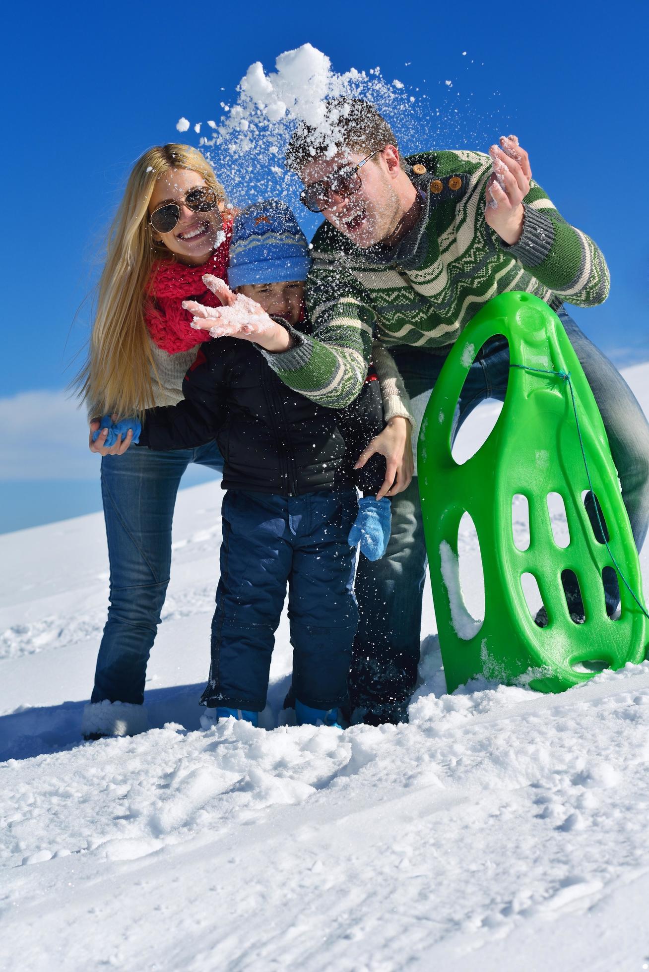 family having fun on fresh snow at winter Stock Free