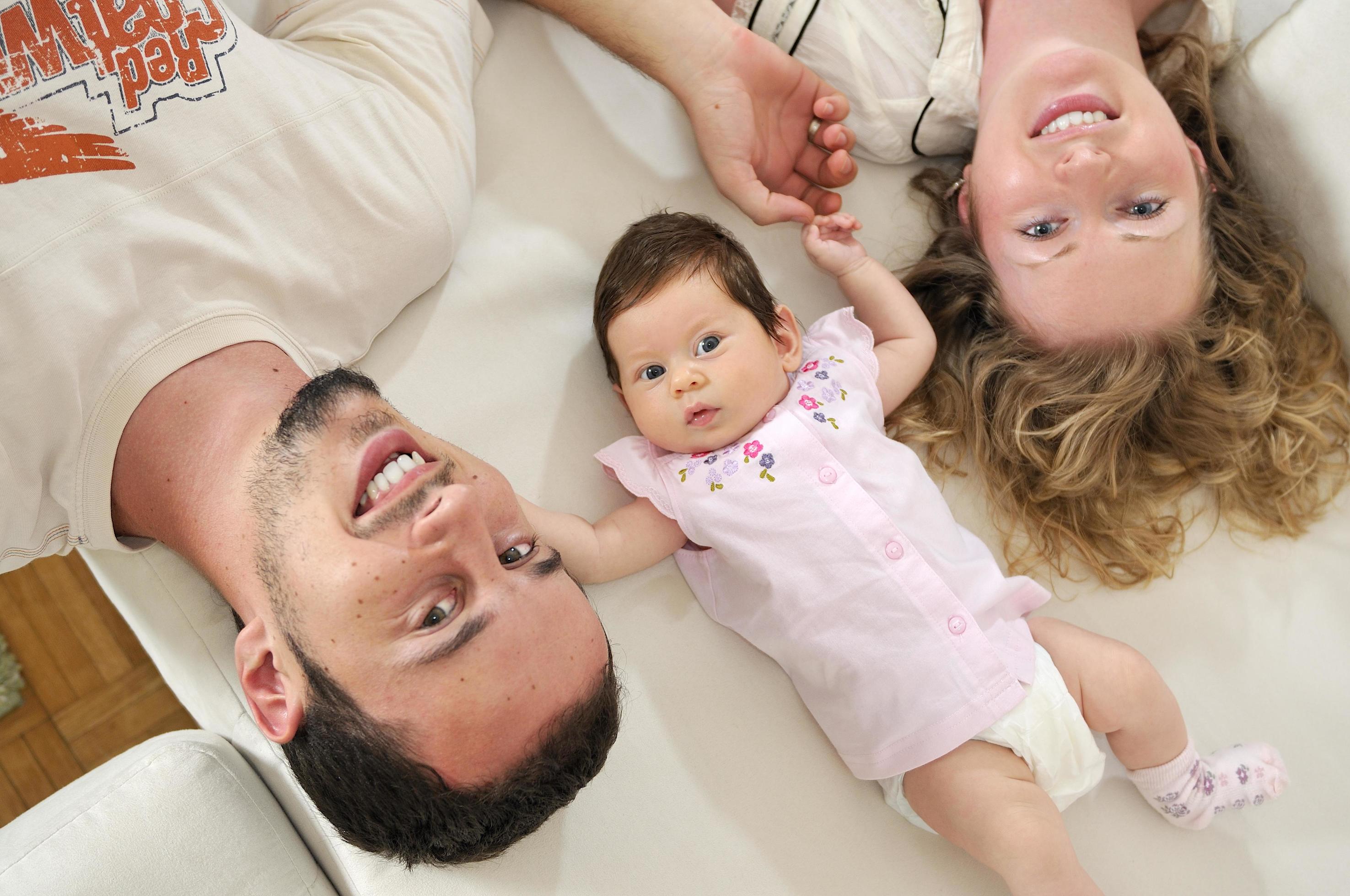 indoor portrait with happy young family and cute little babby Stock Free