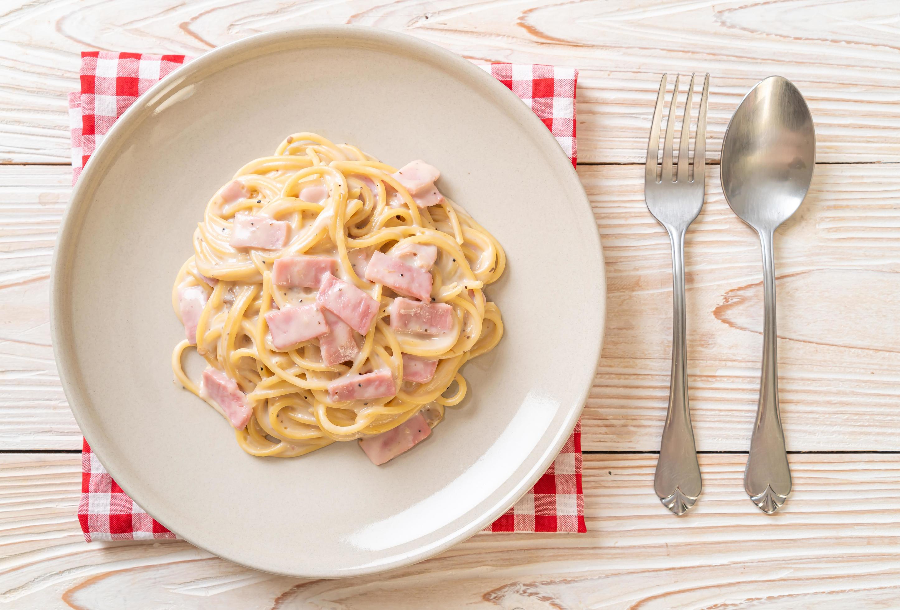 Homemade spaghetti white cream sauce with ham – Italian food style Stock Free