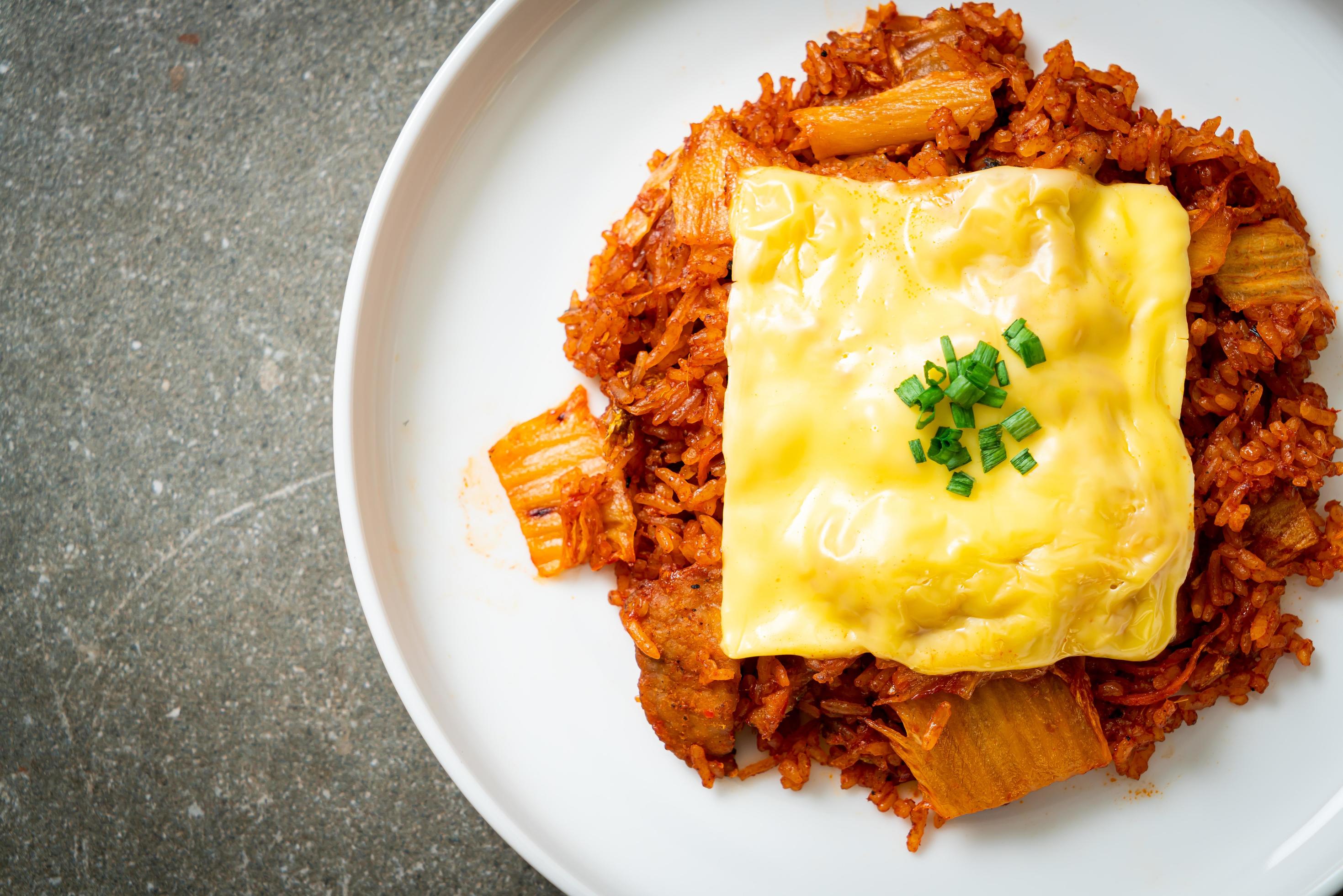 Kimchi fried rice with pork and topped cheese – Asian and fusion food style Stock Free