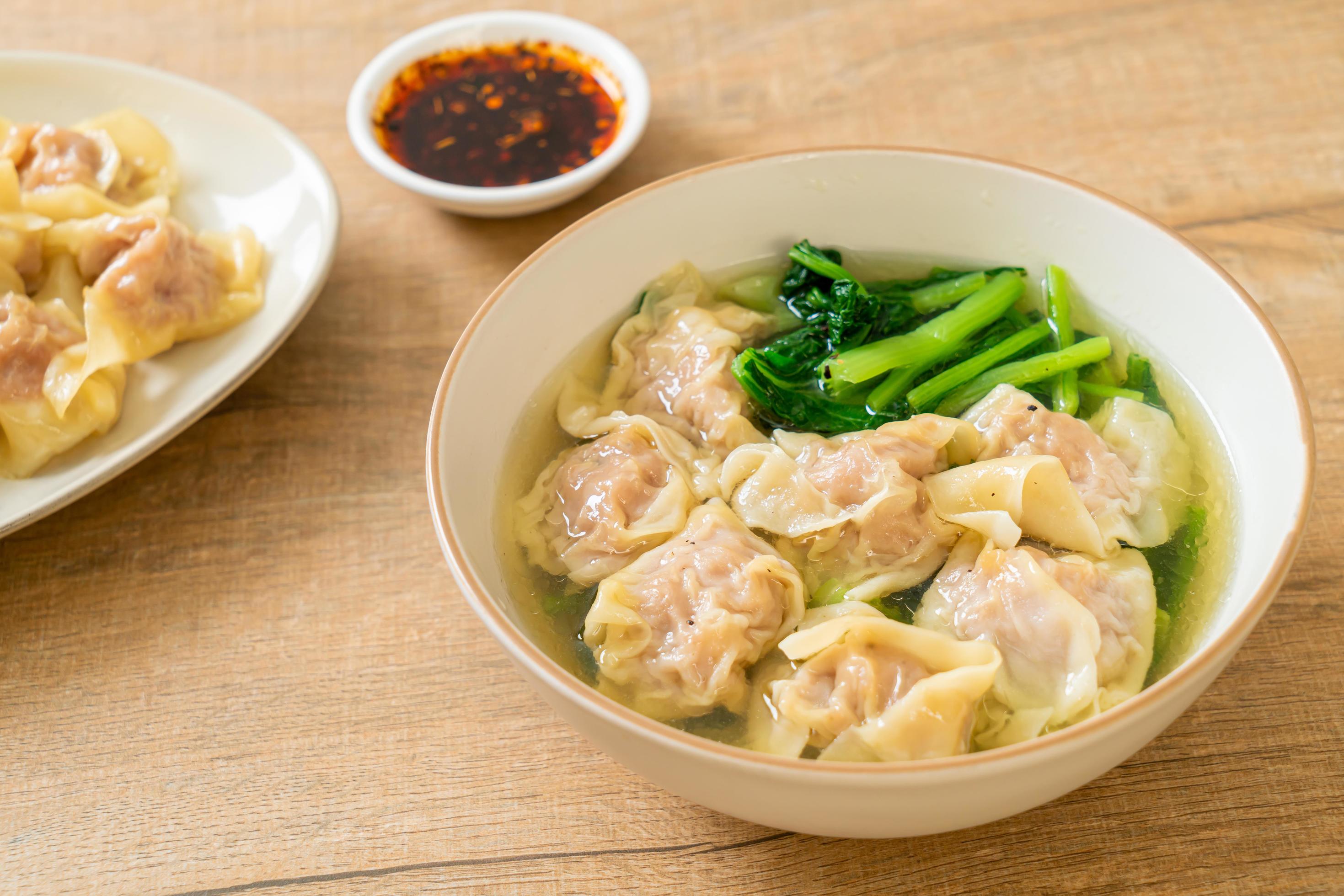 Pork wonton soup or pork dumpling soup with vegetables – Asian food style Stock Free