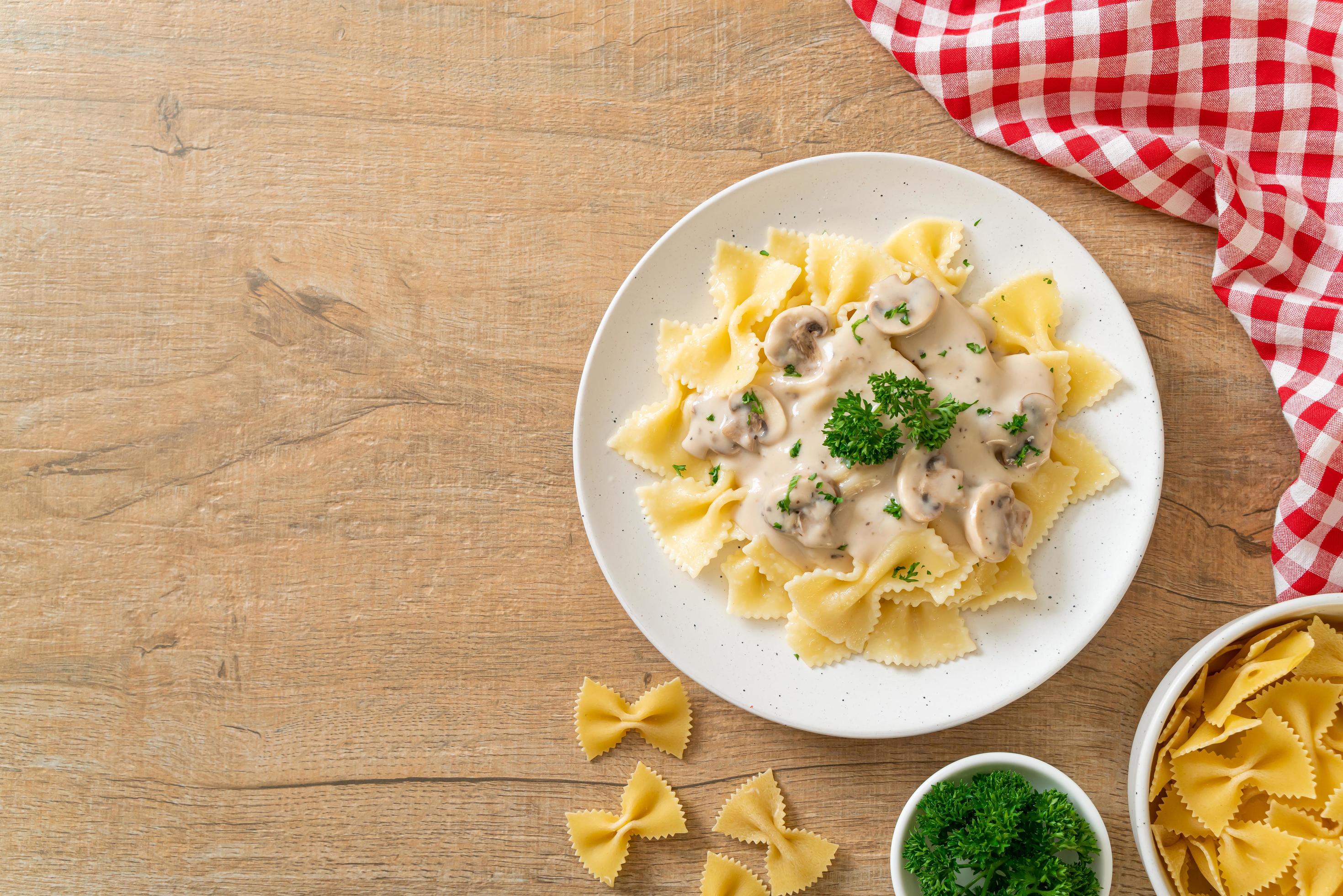 Farfalle pasta with mushroom white cream sauce – Italian food style Stock Free