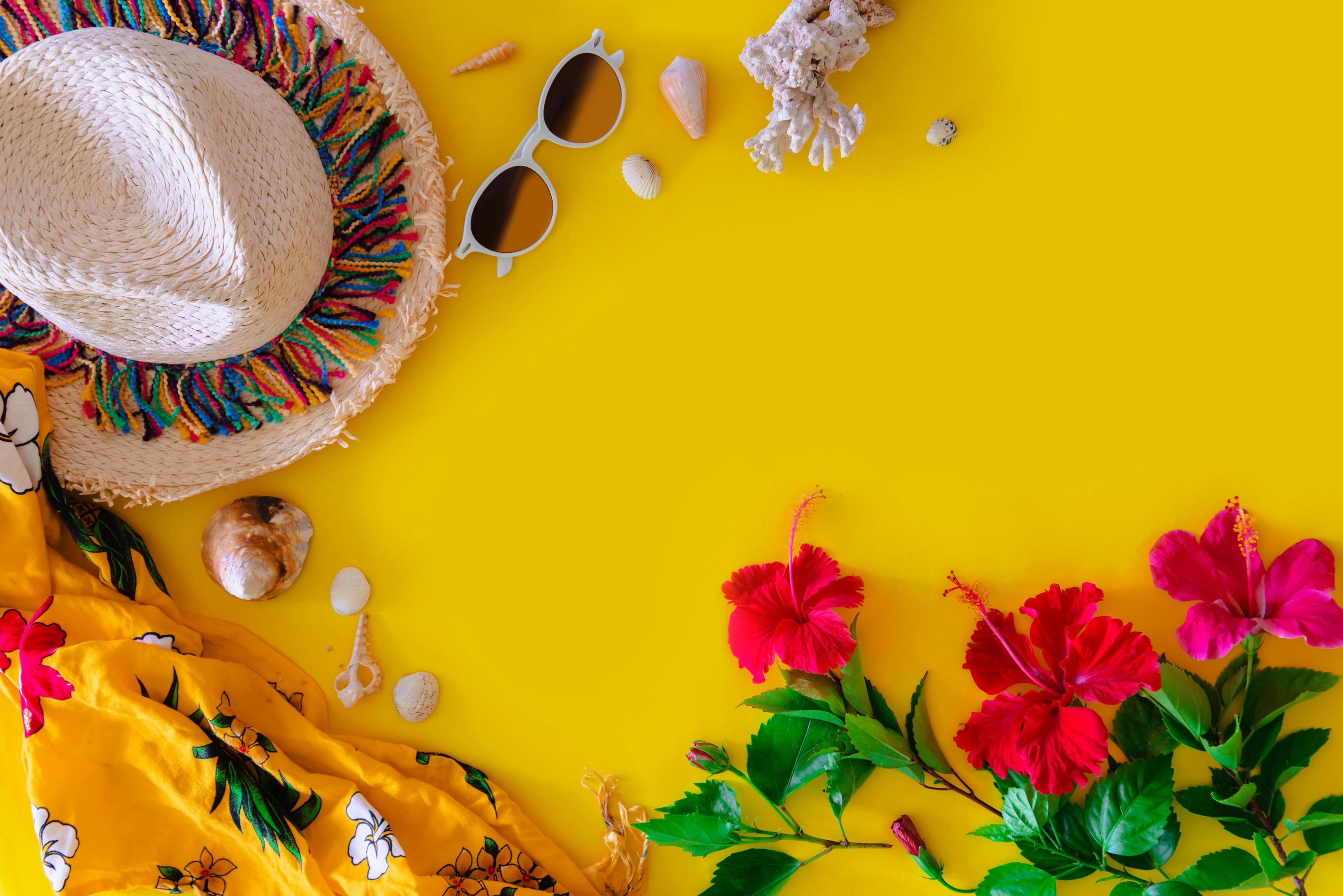 Beach accessories For the traveler on the yellow background – sunglasses, Straw hat, Shell and hibiscus flowers. Beach tourism concept. summer Stock Free