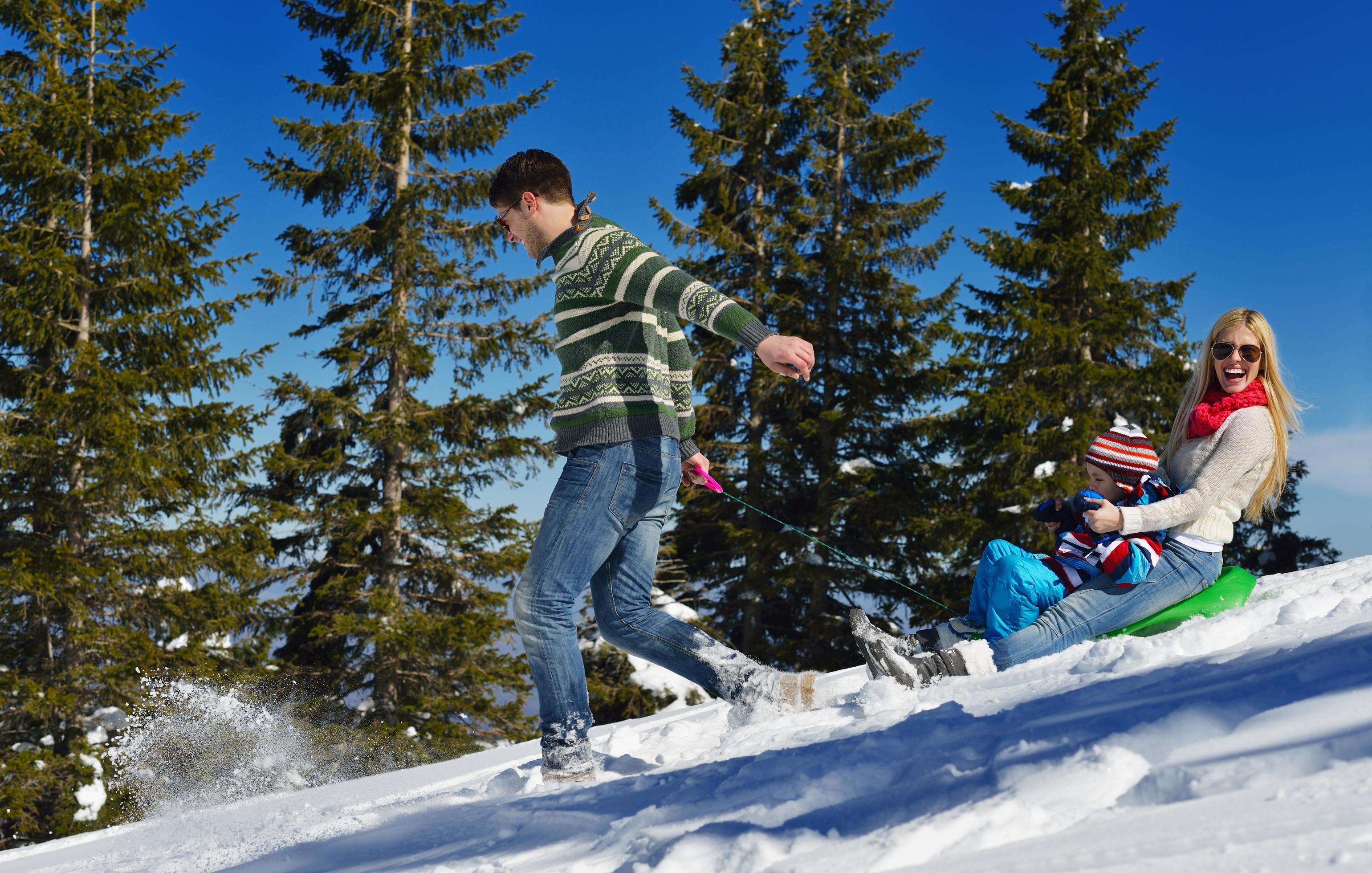 family having fun on fresh snow at winter Stock Free