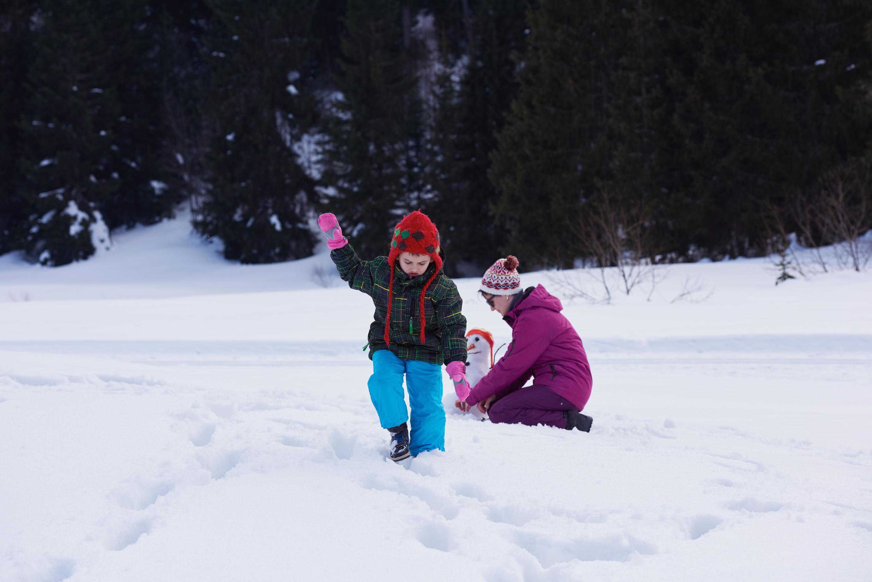 happy family building snowman Stock Free