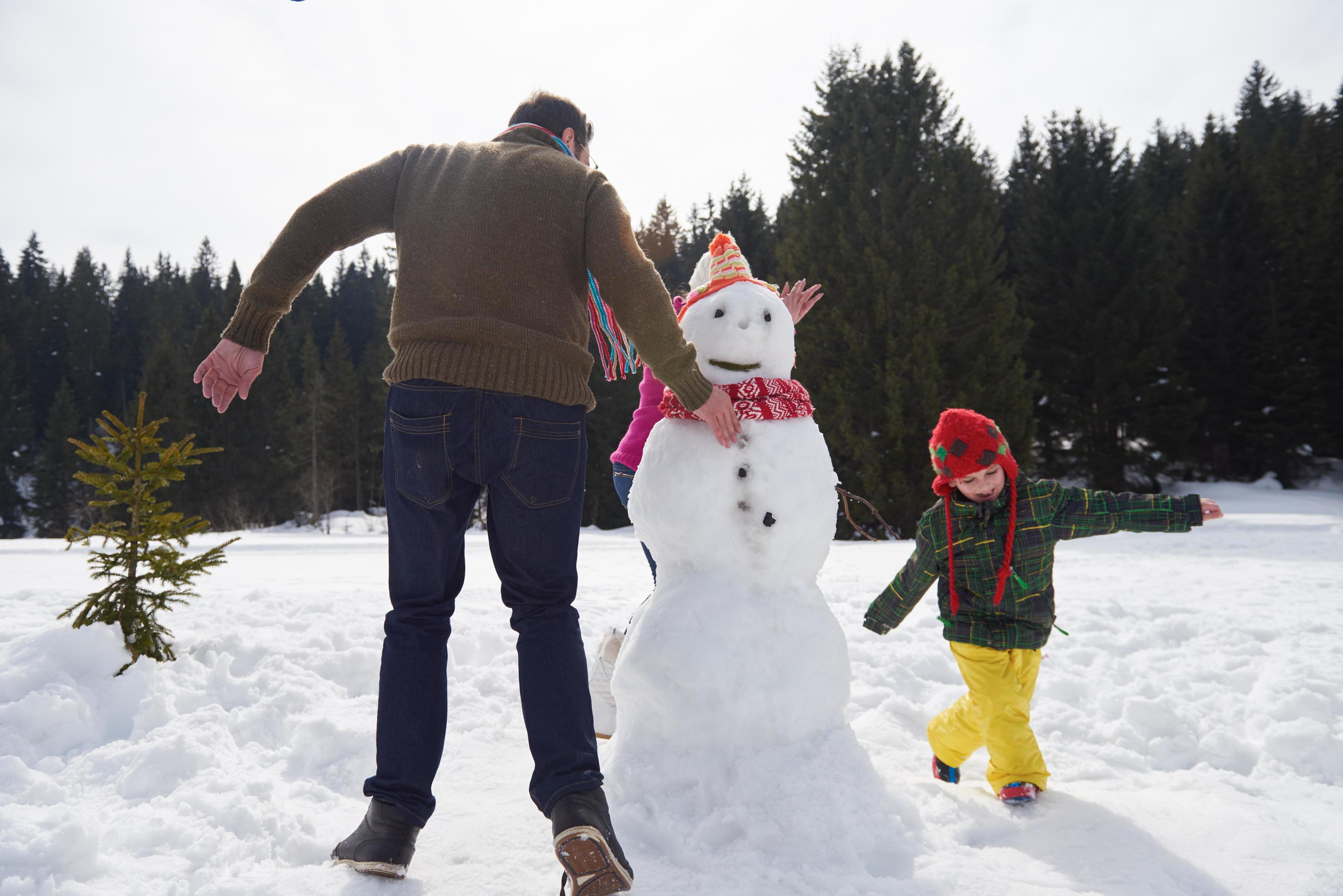 happy family building snowman Stock Free