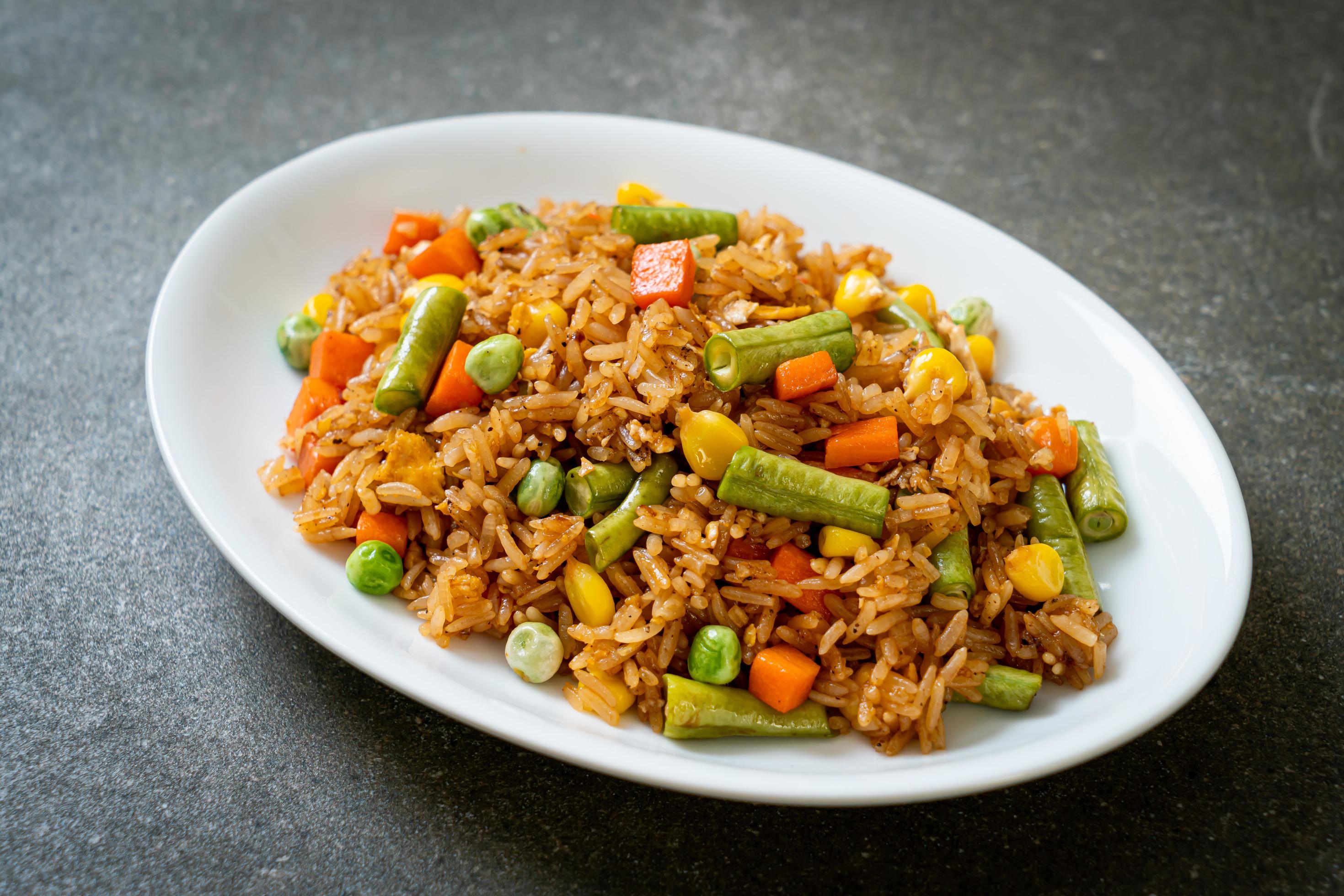 Fried rice with green peas, carrot and corn – vegetarian and healthy food style Stock Free