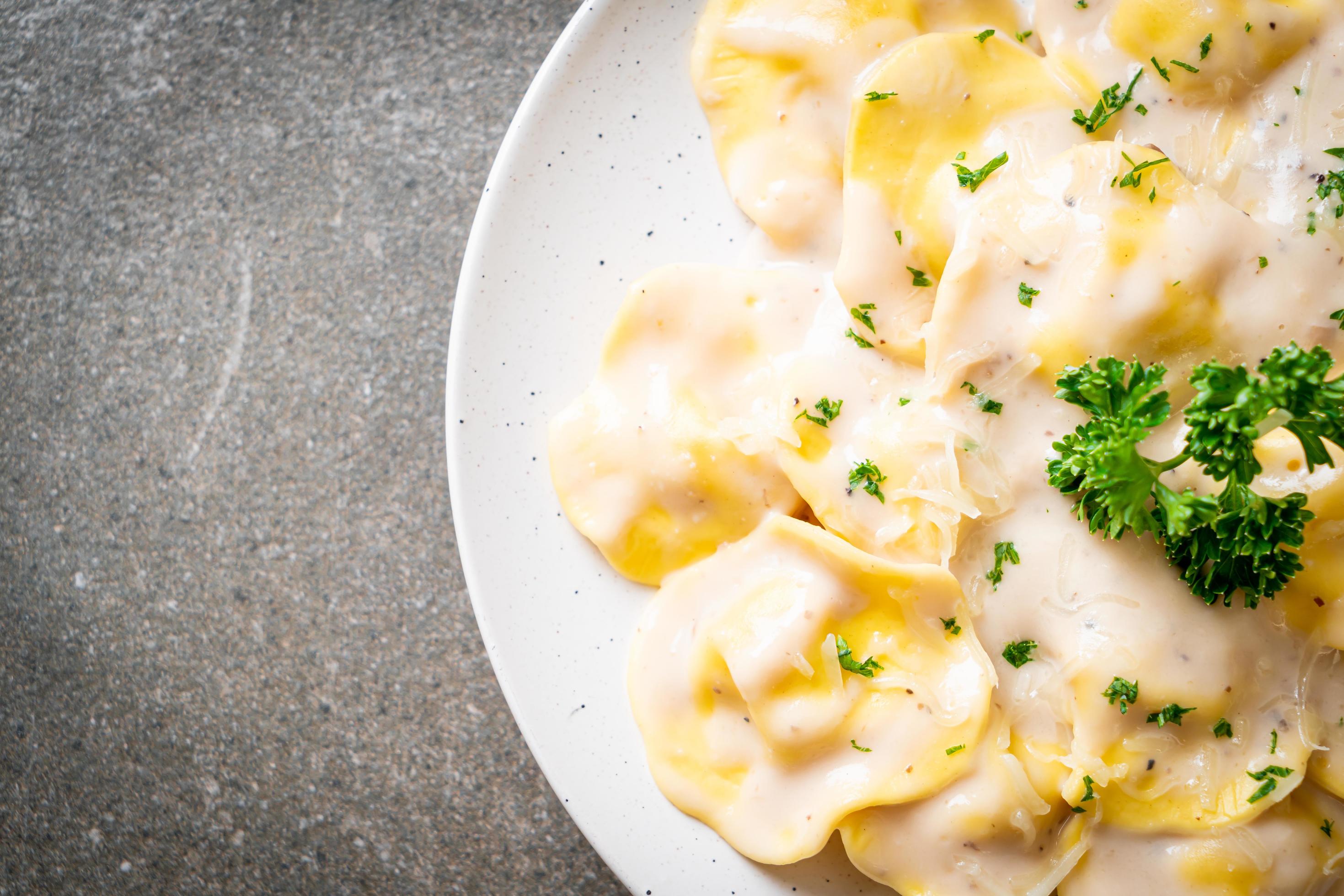 Ravioli pasta with mushroom cream sauce and cheese – Italian food style Stock Free