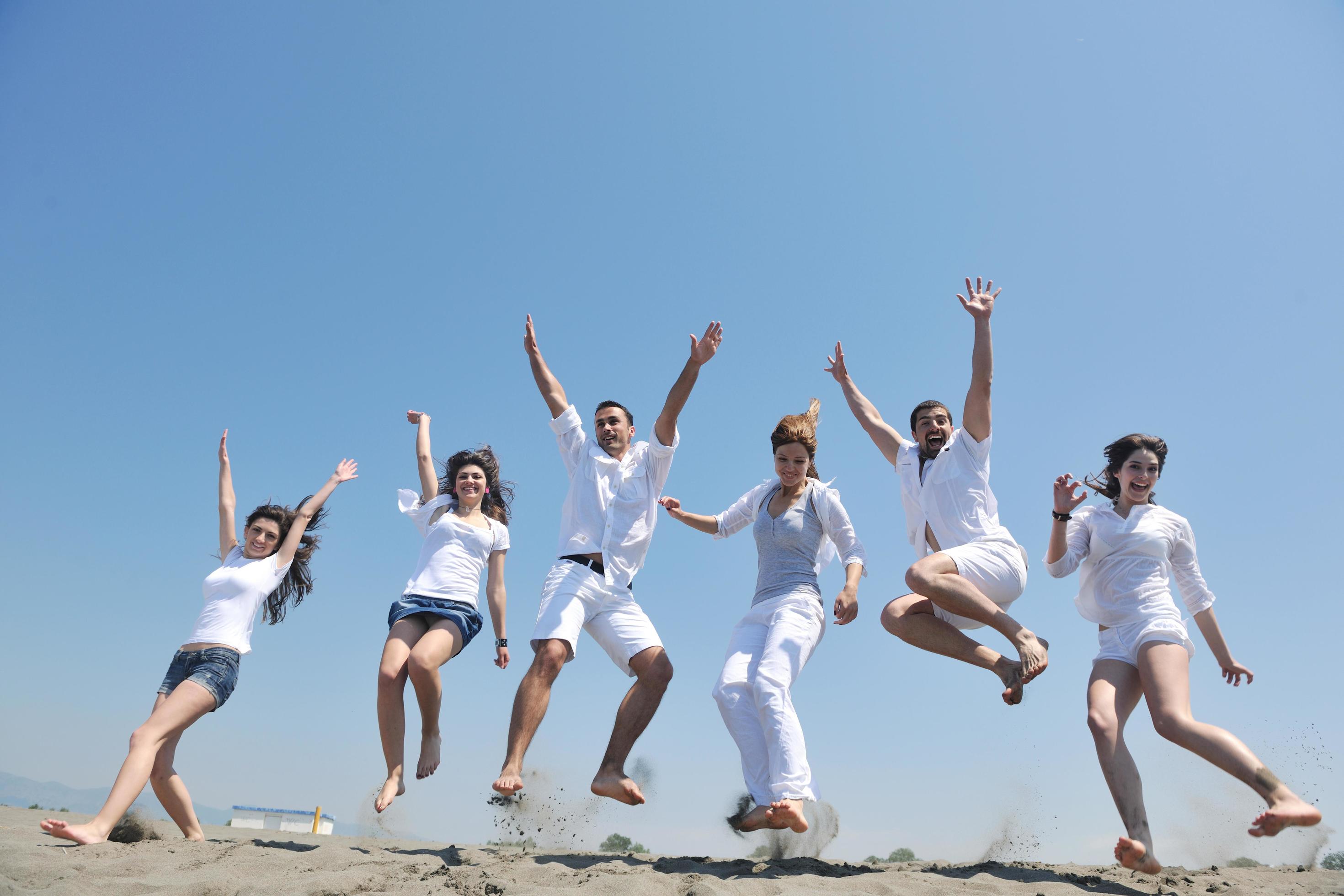 happy people group have fun and running on beach Stock Free