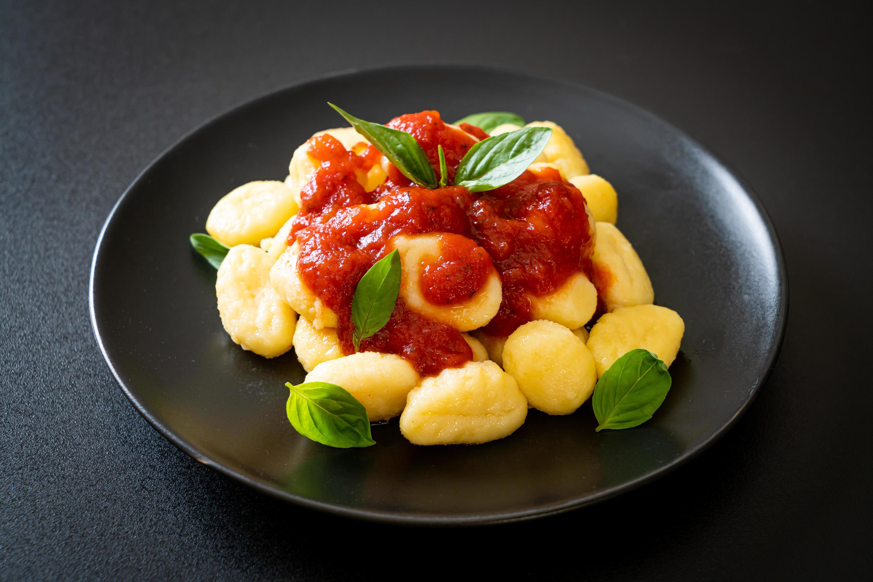 Gnocchi in tomato sauce with cheese – Italian food style Stock Free