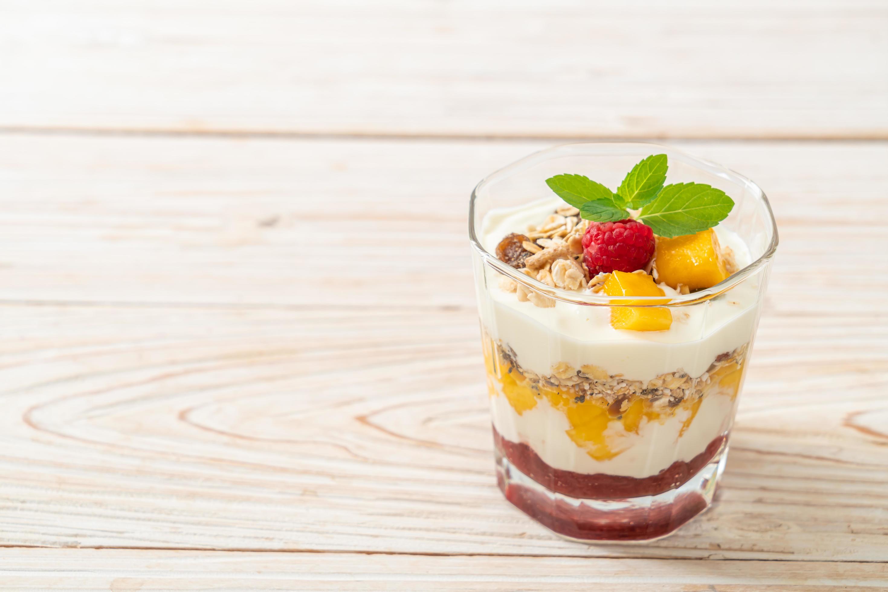 Homemade fresh mango and fresh raspberry with yogurt and granola – healthy food style Stock Free