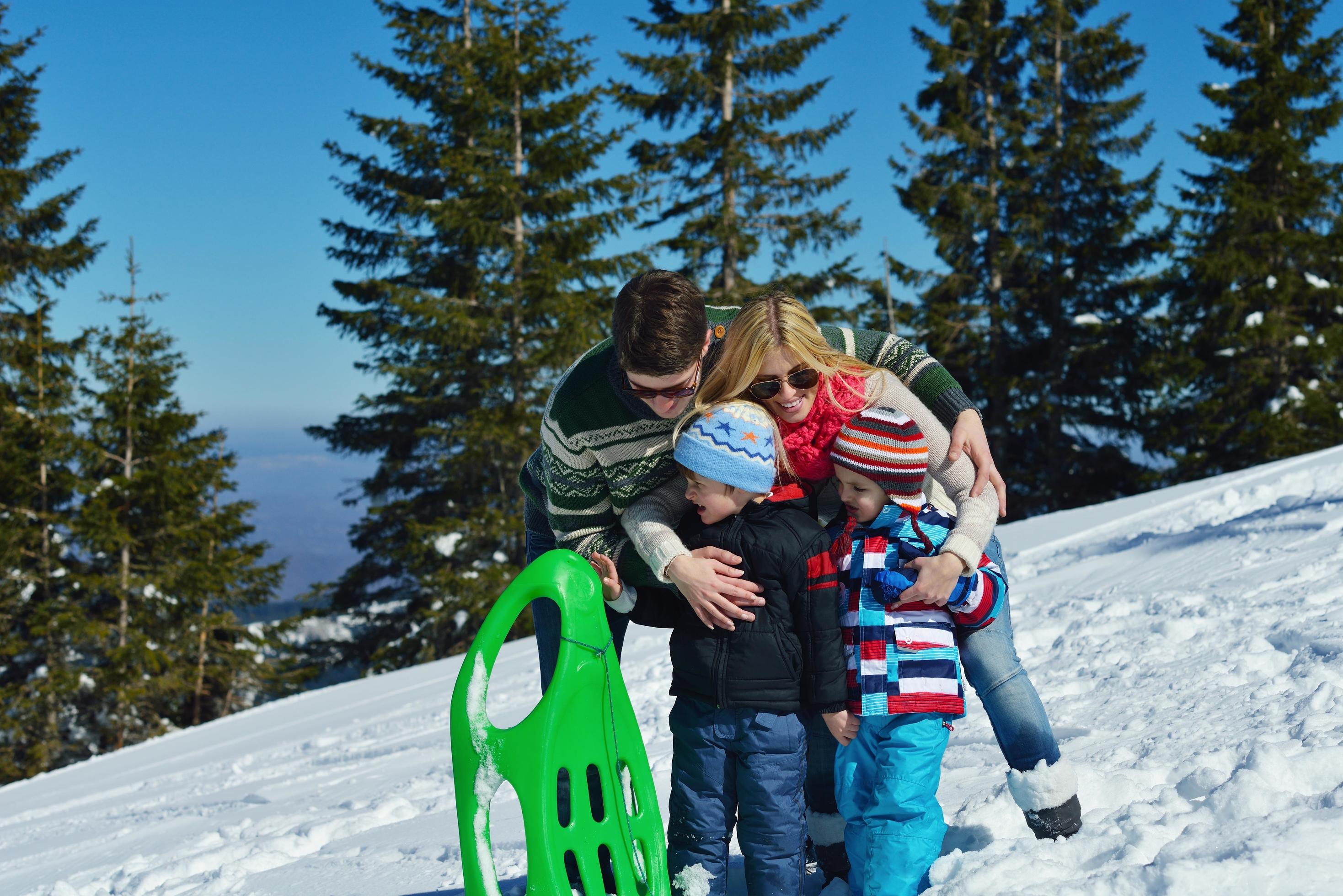 family having fun on fresh snow at winter Stock Free