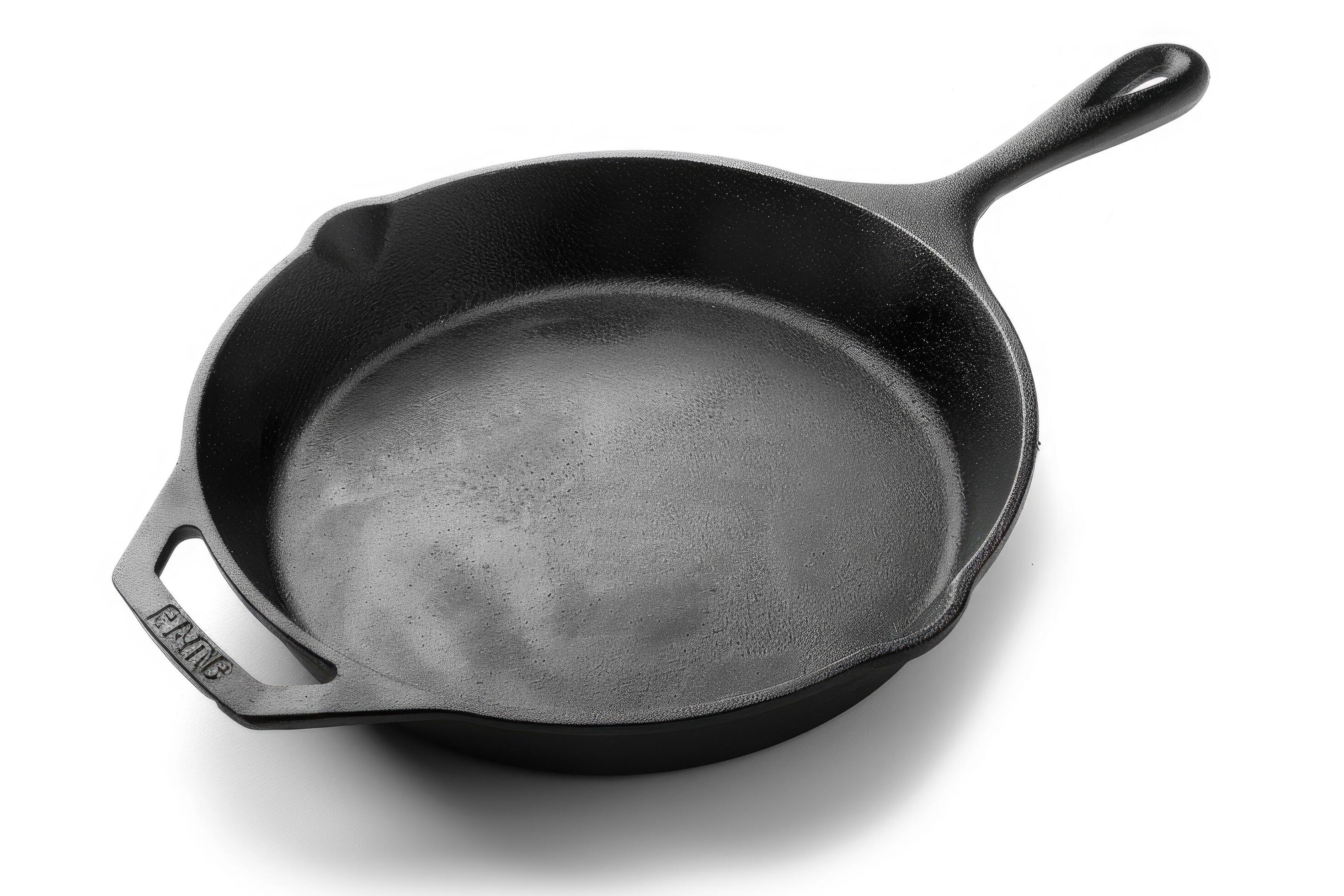 Black cast iron skillet on a white background. Stock Free