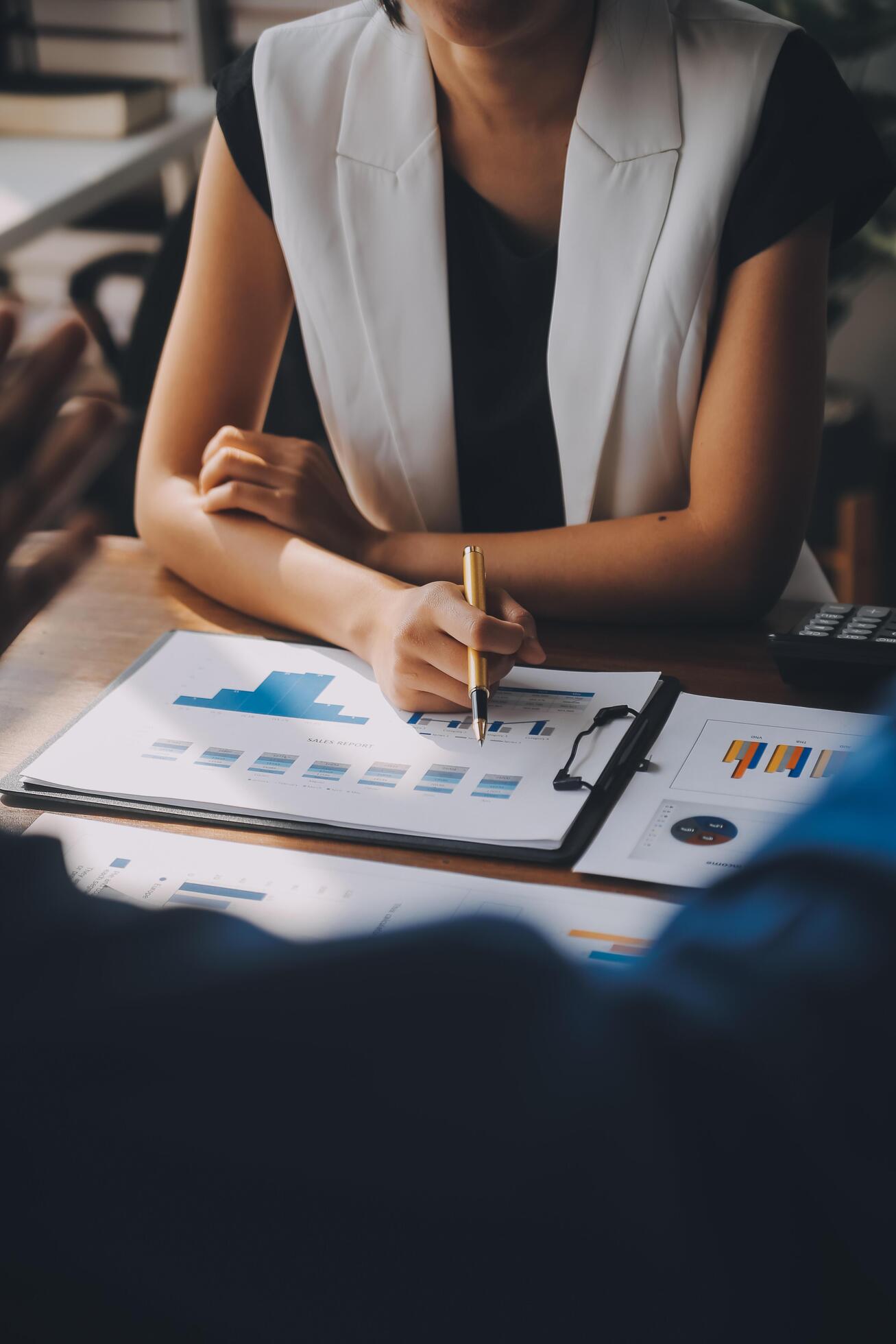 Close up of Business team analyzing income charts and graphs with modern laptop computer. Business analysis and strategy concept. Stock Free