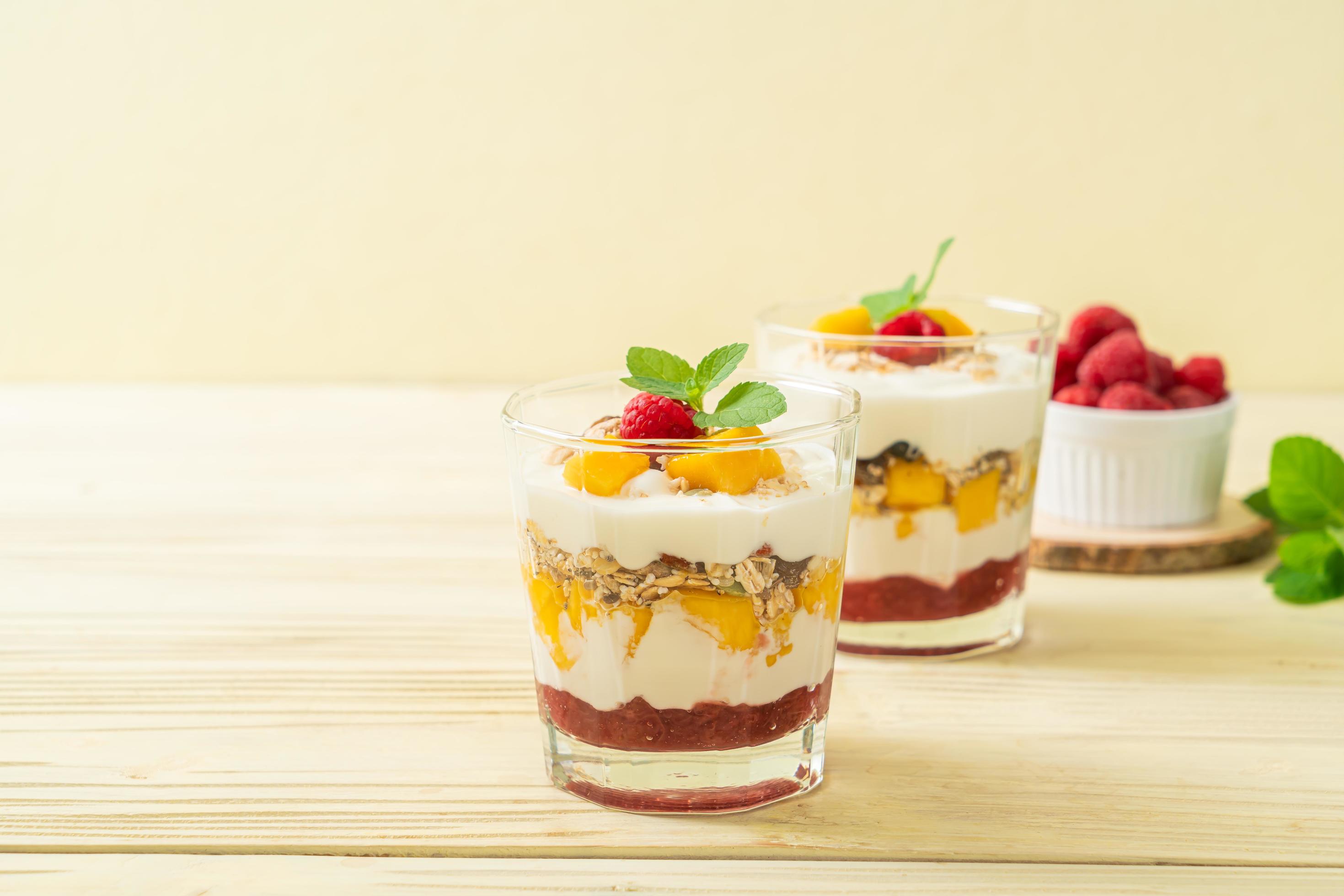 Homemade fresh mango and fresh raspberry with yogurt and granola – healthy food style Stock Free