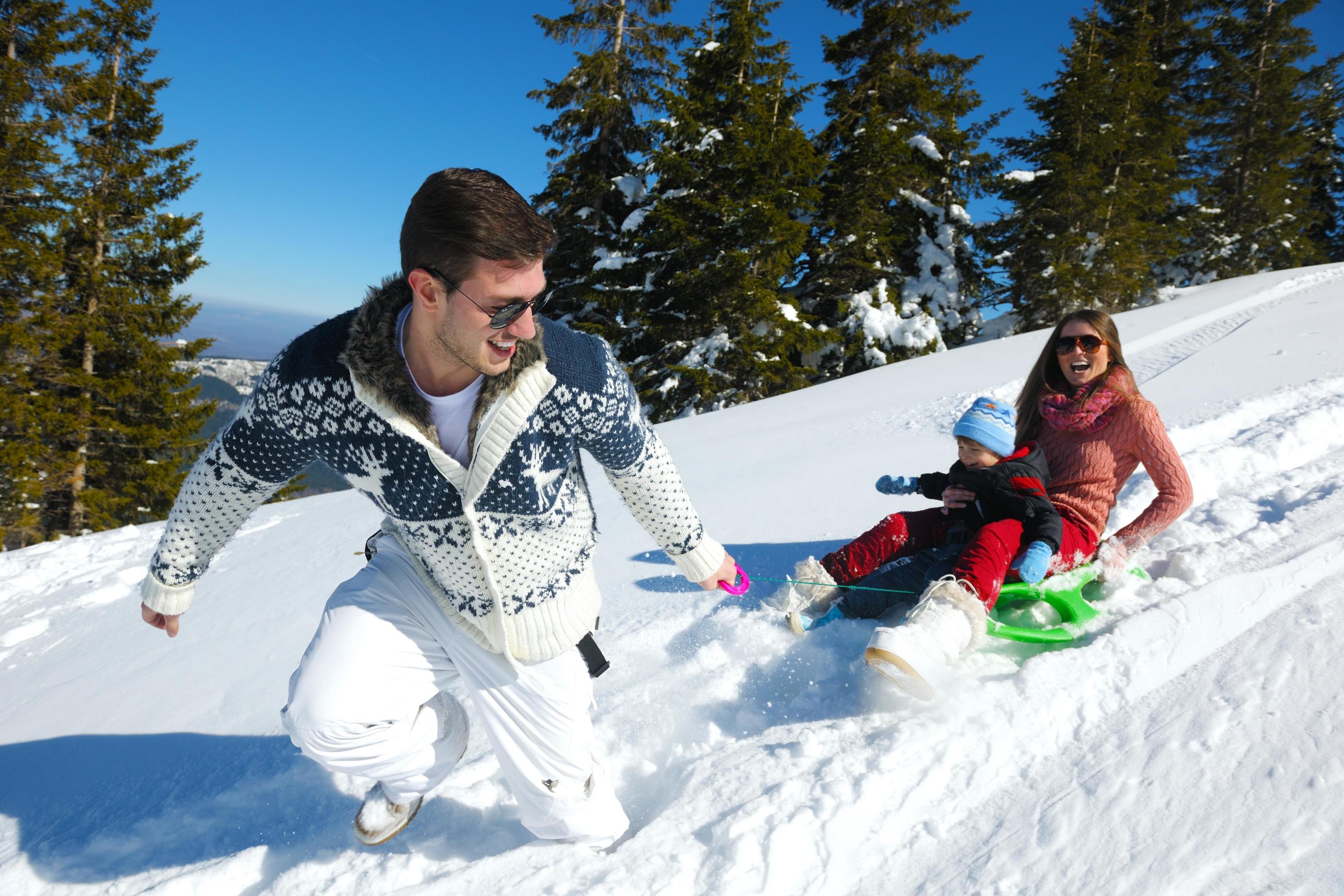 family having fun on fresh snow at winter Stock Free