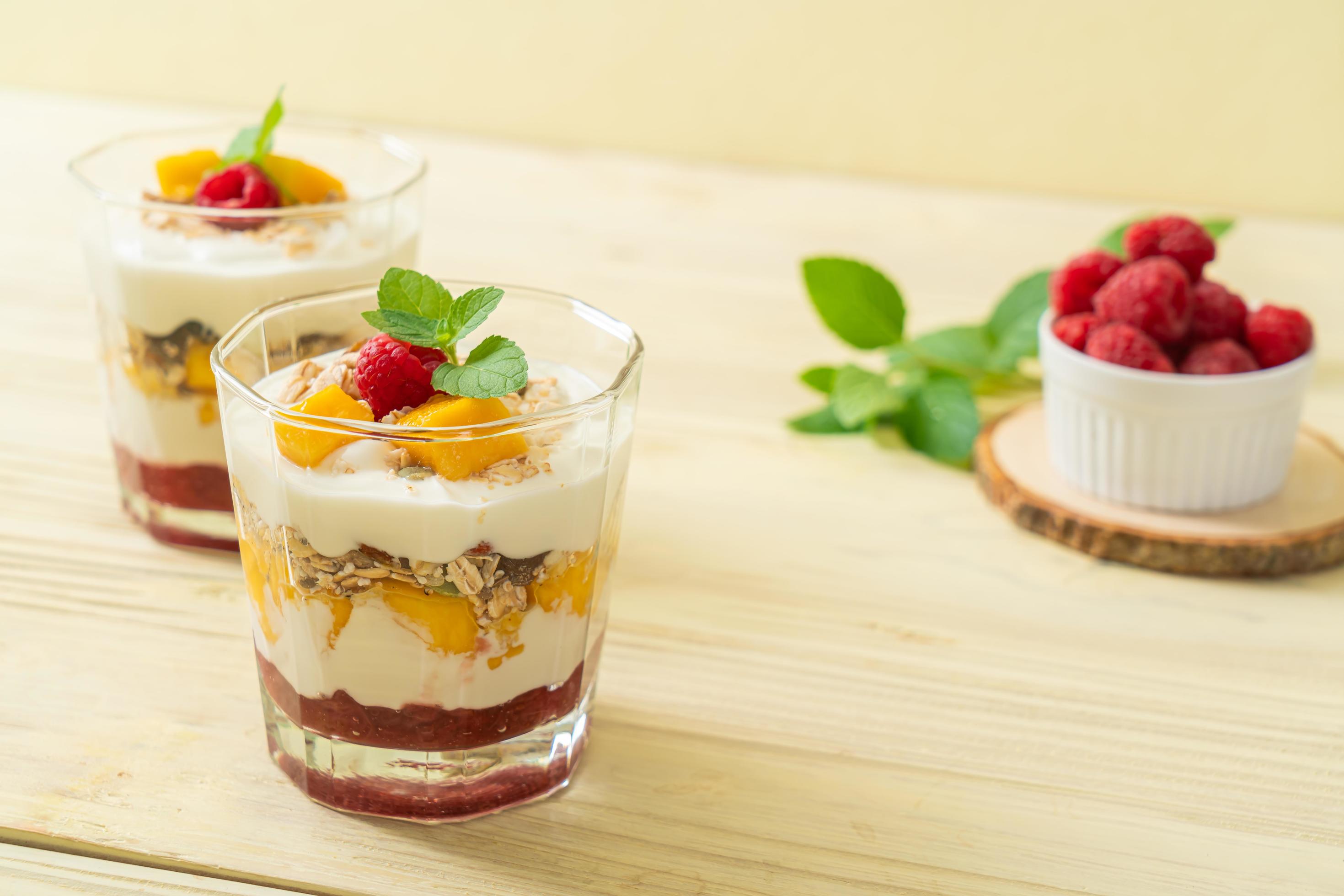 Homemade fresh mango and fresh raspberry with yogurt and granola – healthy food style Stock Free