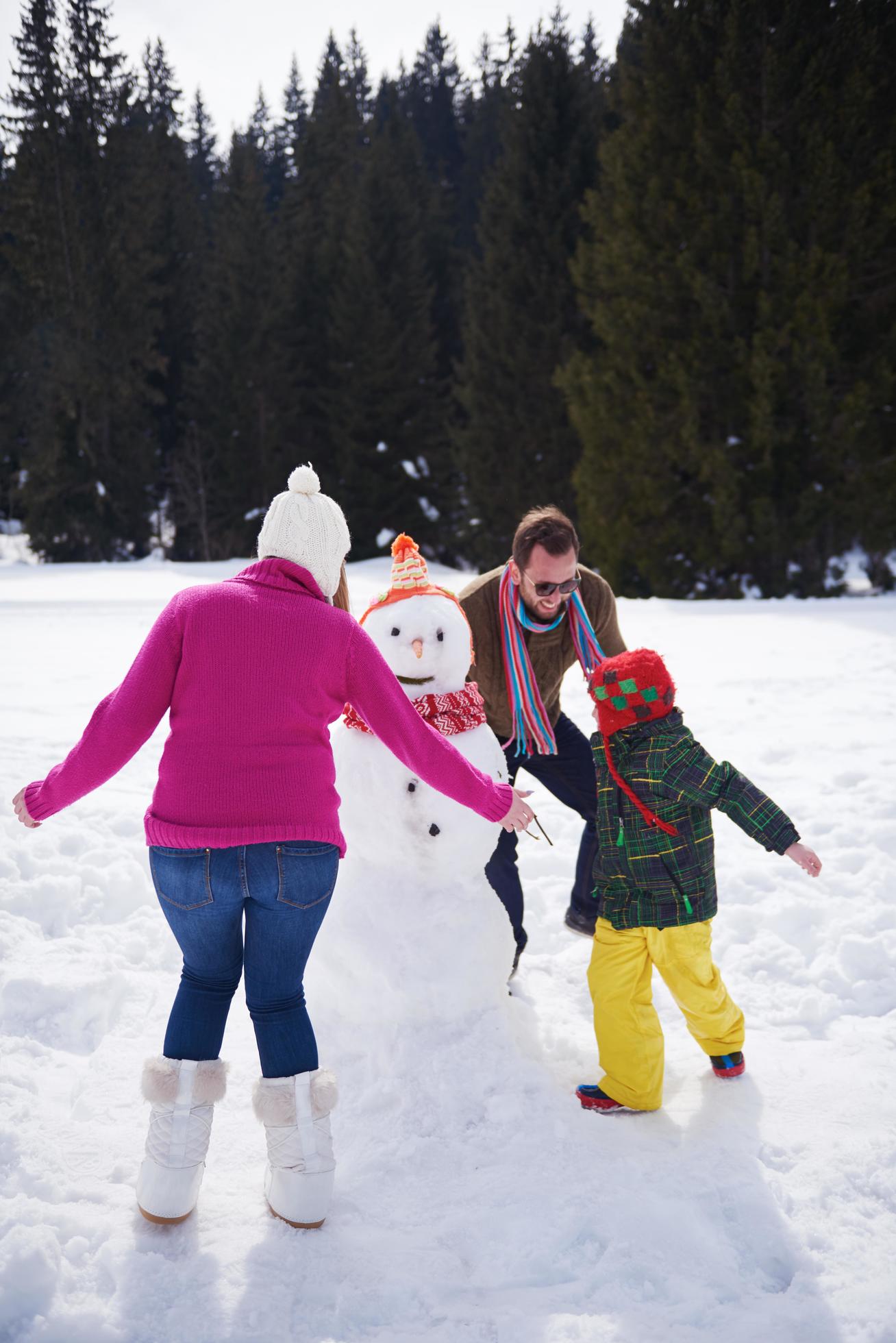 happy family building snowman Stock Free