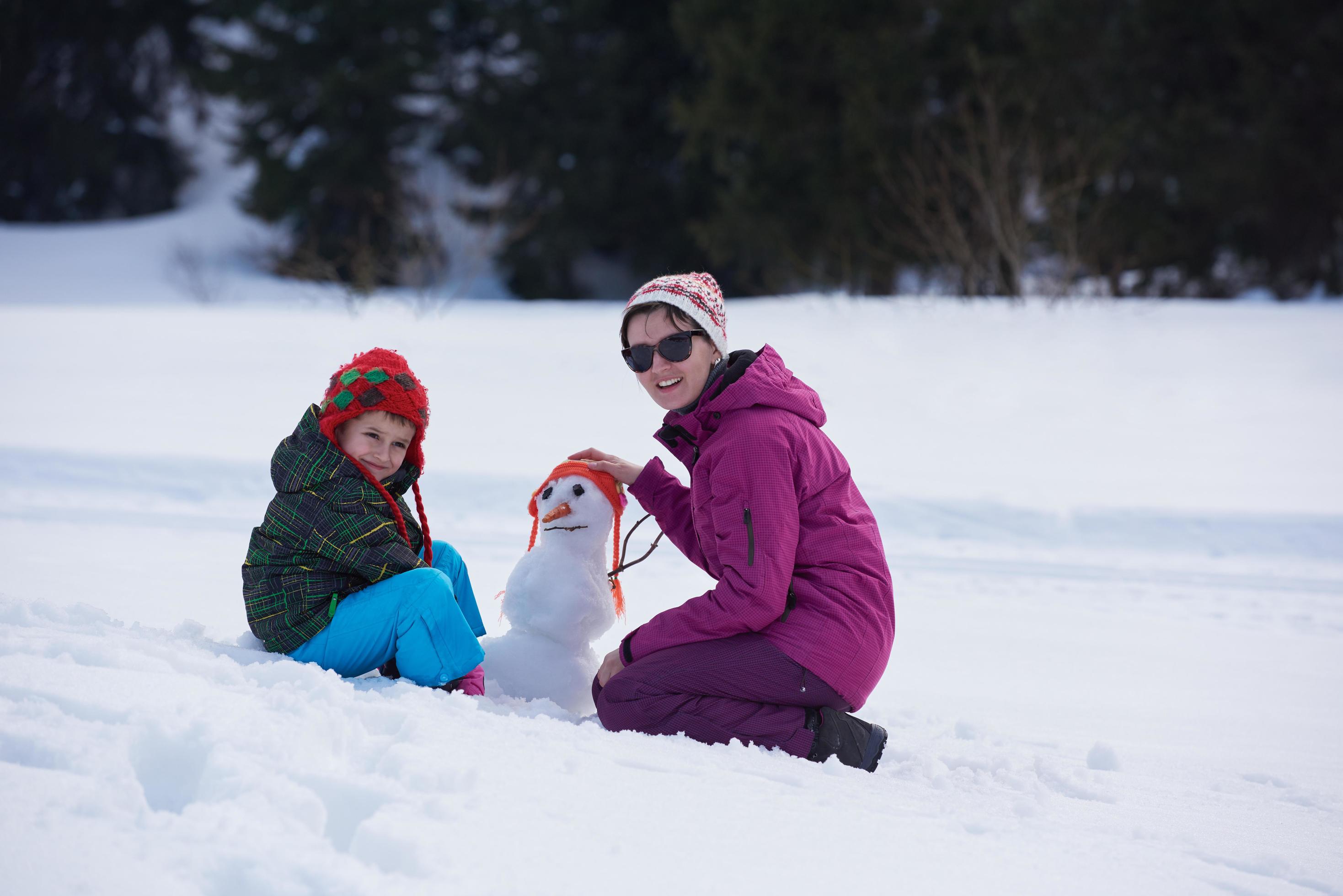 happy family building snowman Stock Free