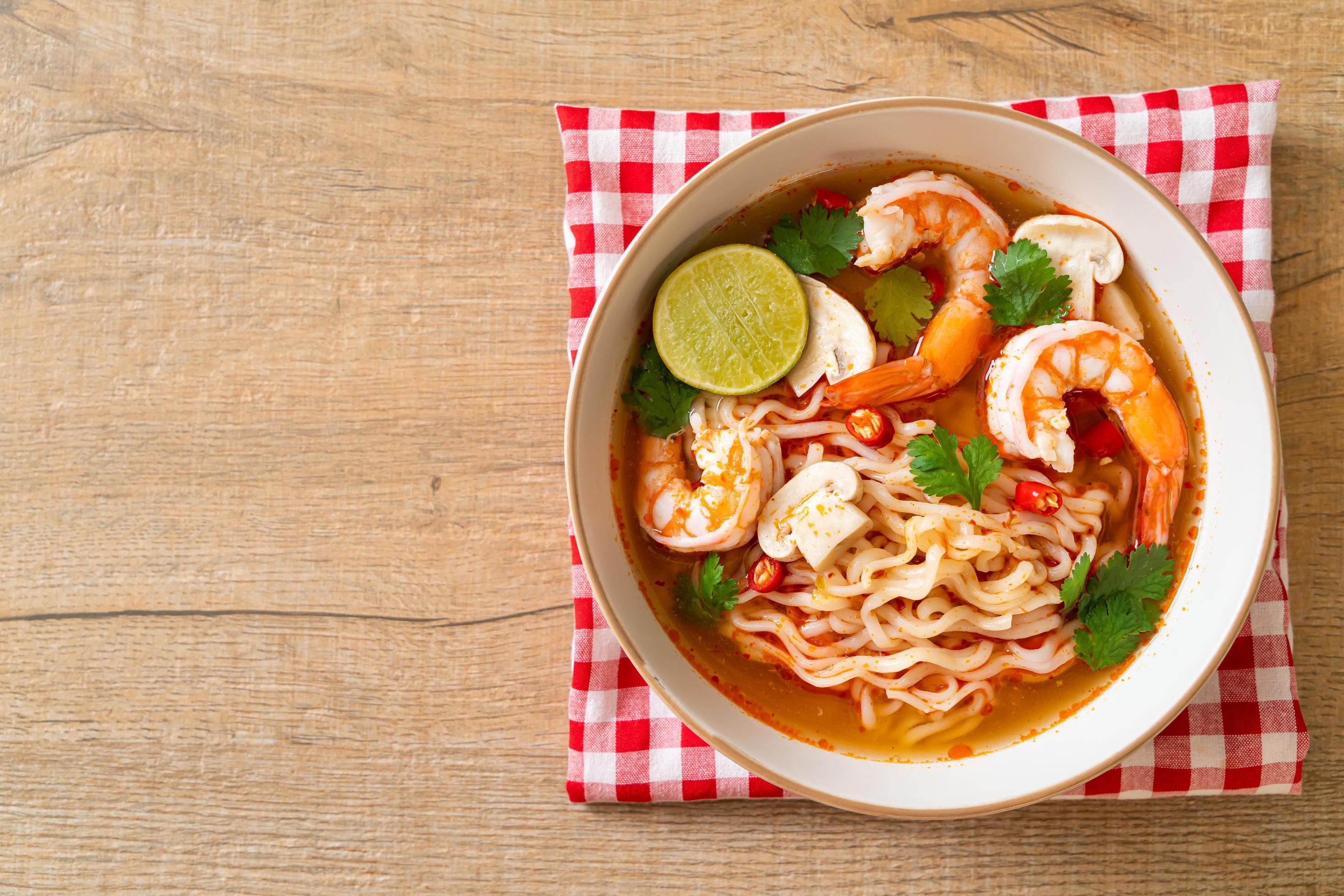 Instant noodles ramen in spicy soup with shrimps, or Tom Yum Kung – Asian food style Stock Free