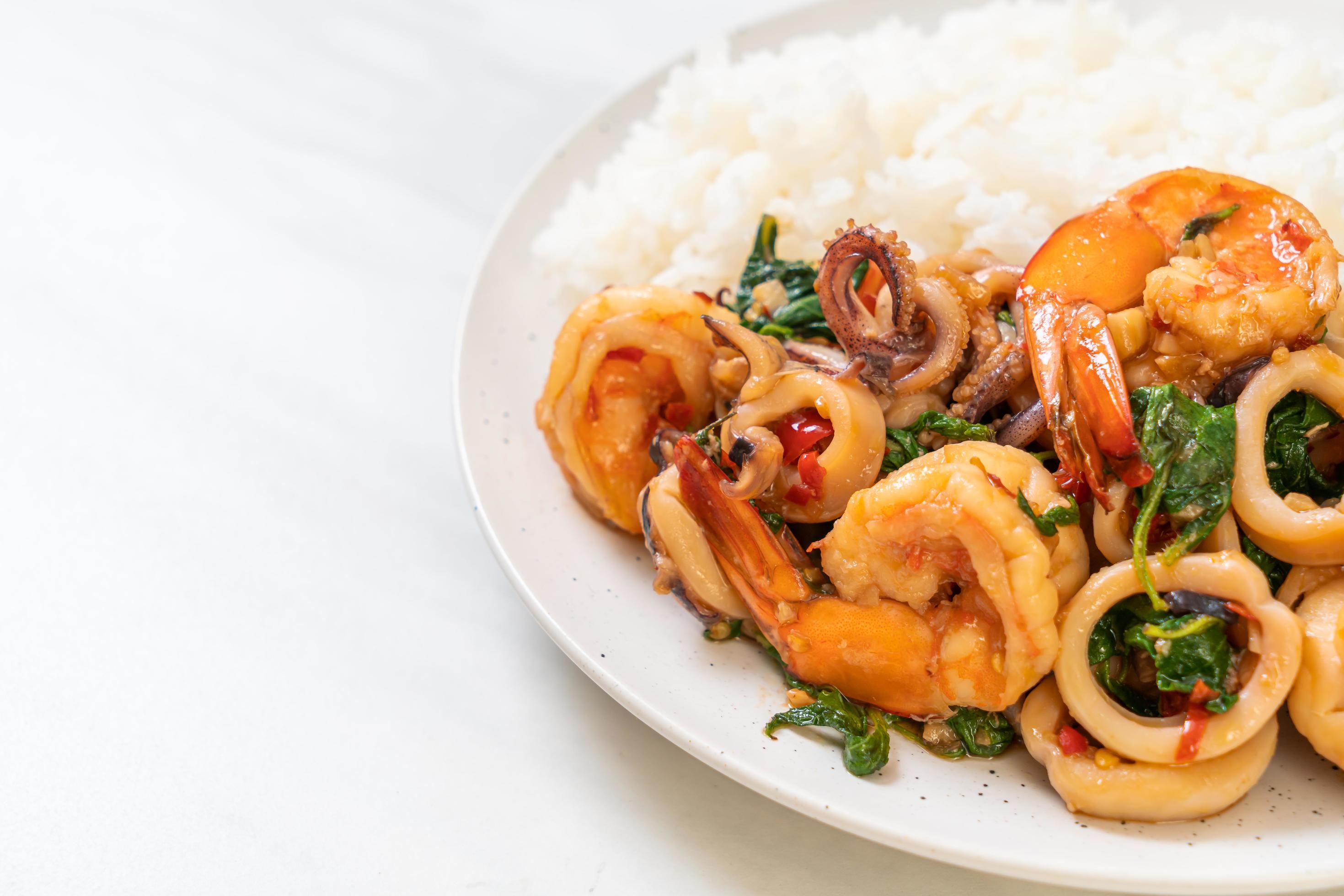 Rice and stir-fried seafood of shrimp and squid with Thai basil – Asian food style Stock Free