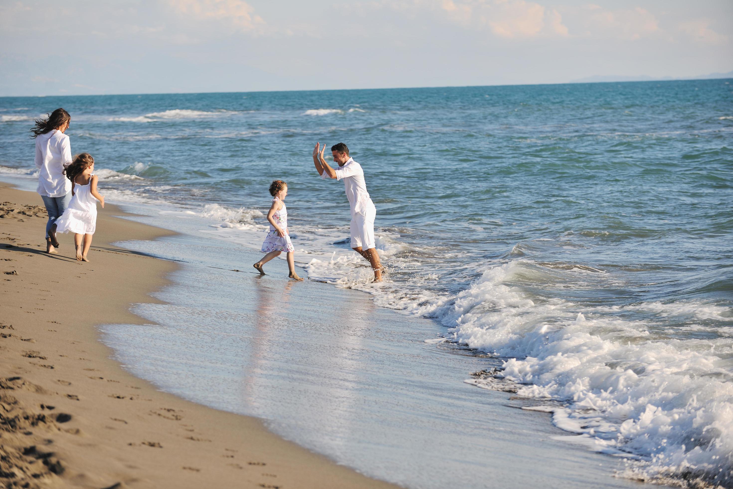 happy young family have fun on beach Stock Free