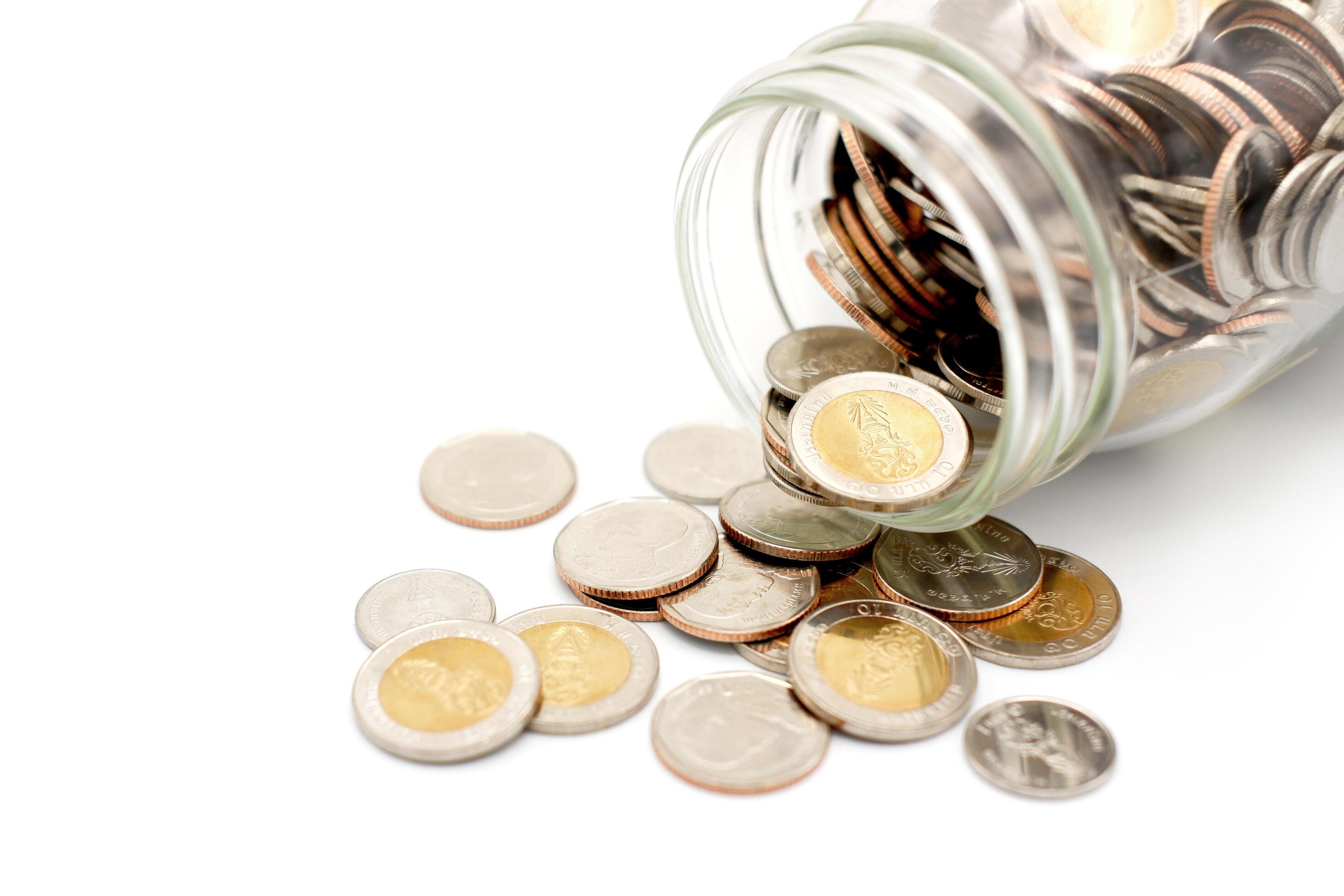 Thai Baht coins in a glass jar. Business and finance concept. Stock Free