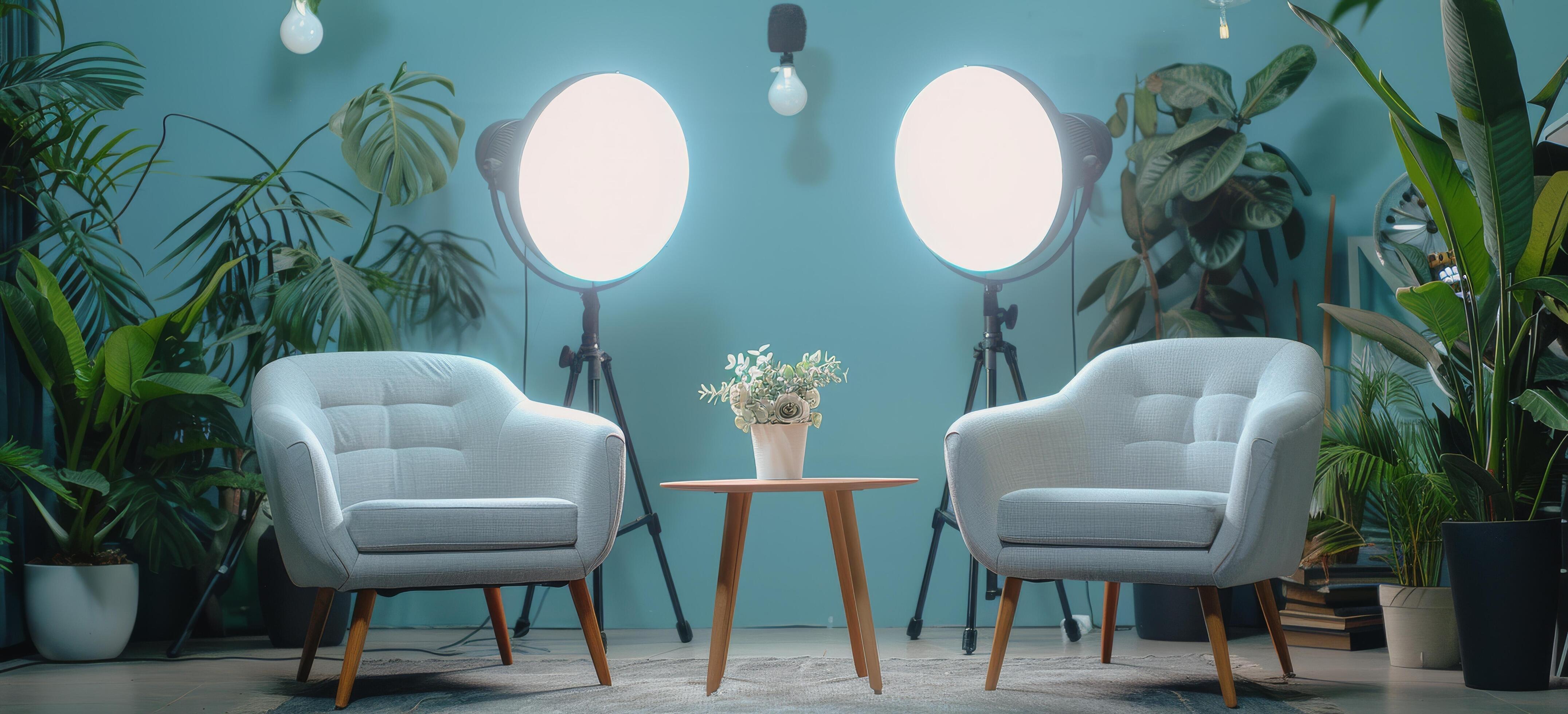 Two Teal Armchairs With Lamps and Plants in a Room With a Light Blue Wall Stock Free