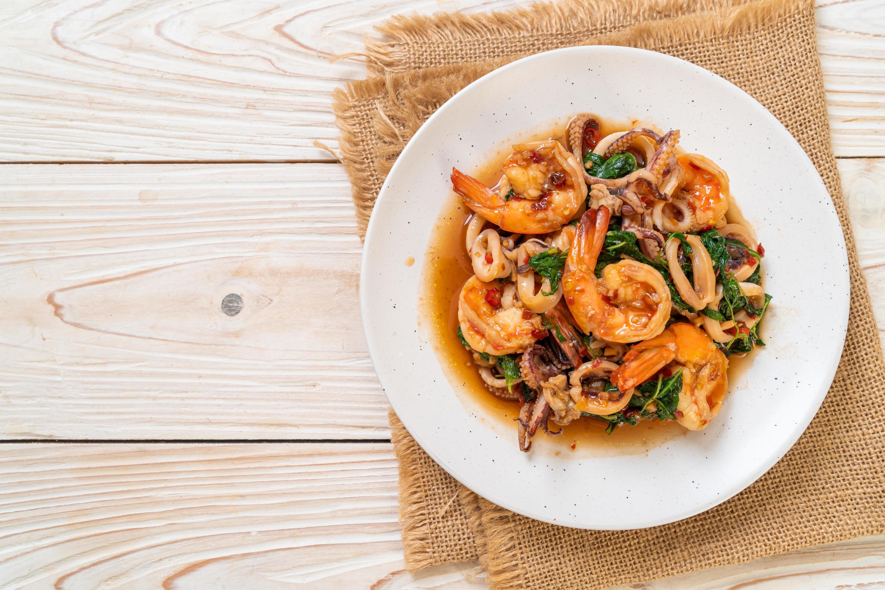 Stir-fried seafood of shrimp and squid with Thai basil – Asian food style Stock Free