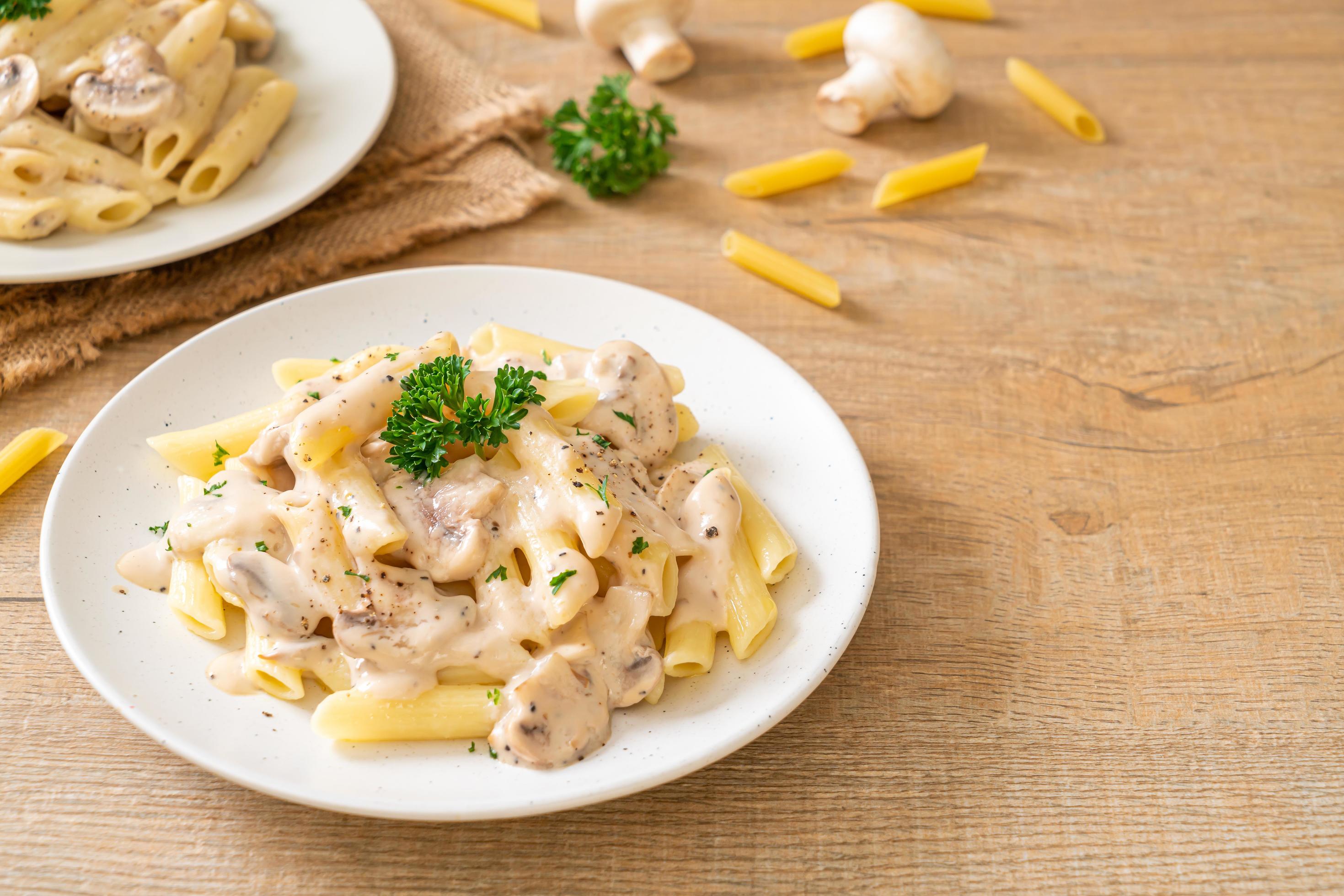 Penne pasta carbonara cream sauce with mushroom – Italian food style Stock Free