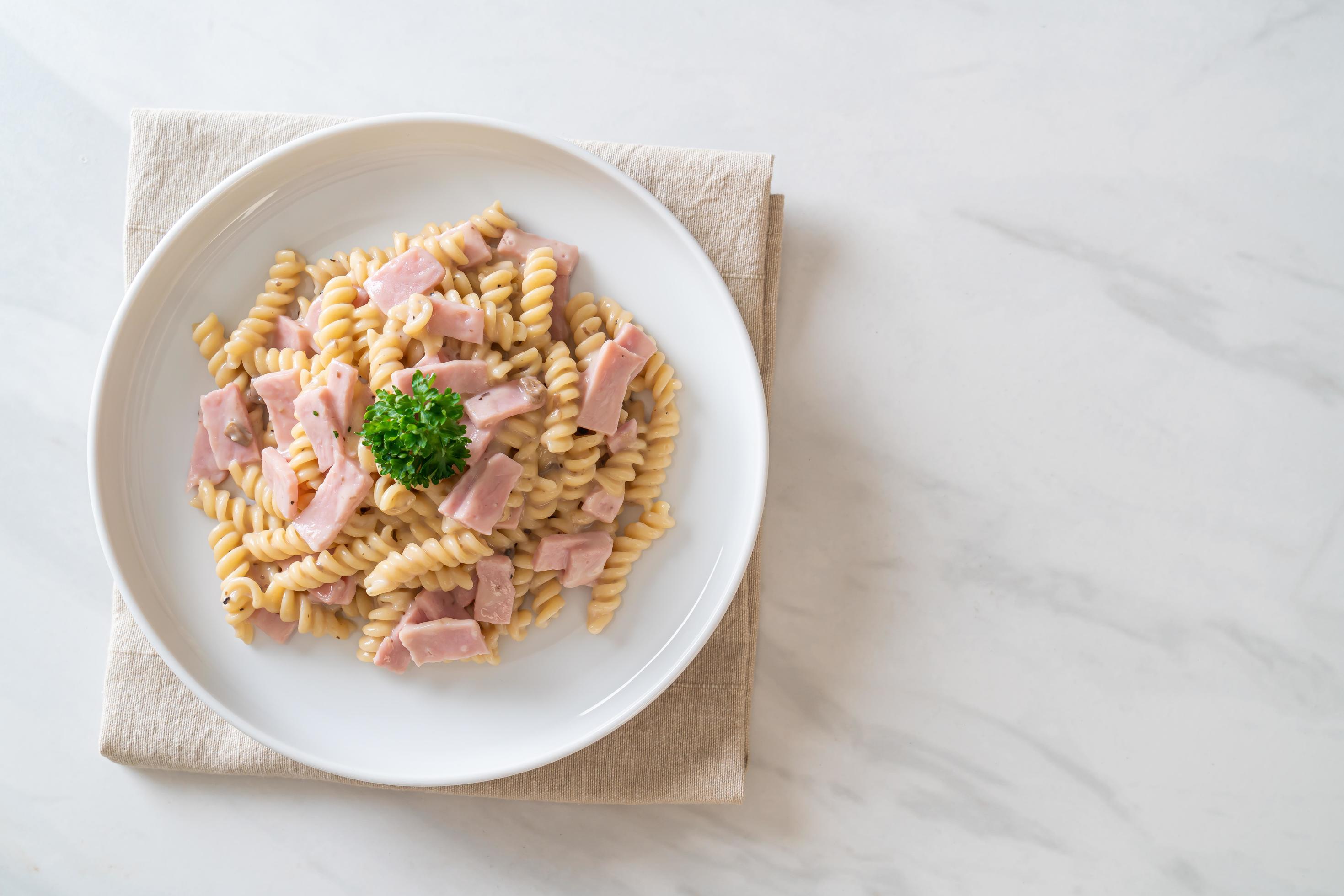 Spirali or spiral pasta mushroom cream sauce with ham – Italian food style Stock Free