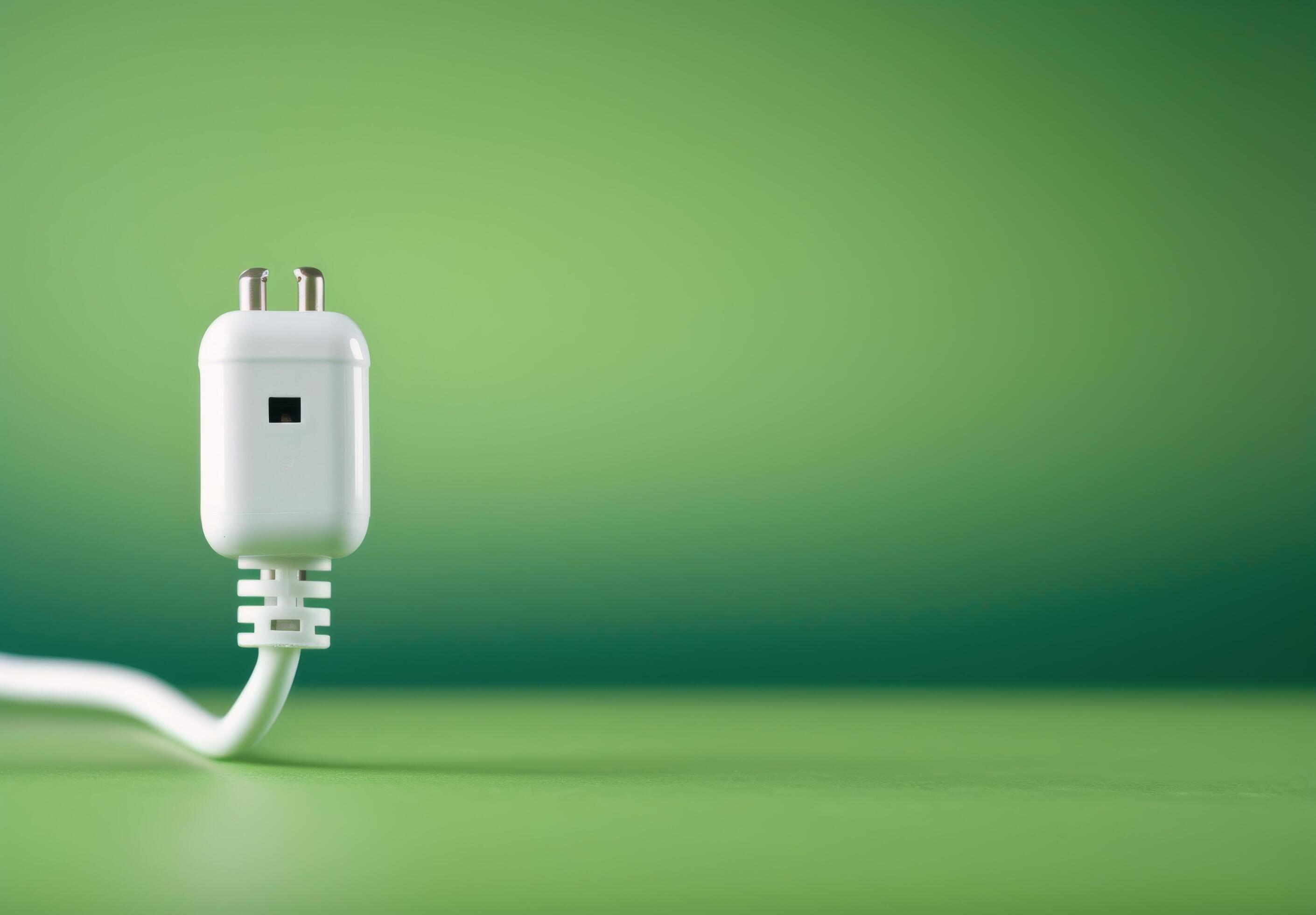 White Electrical Plug on Green Background Stock Free