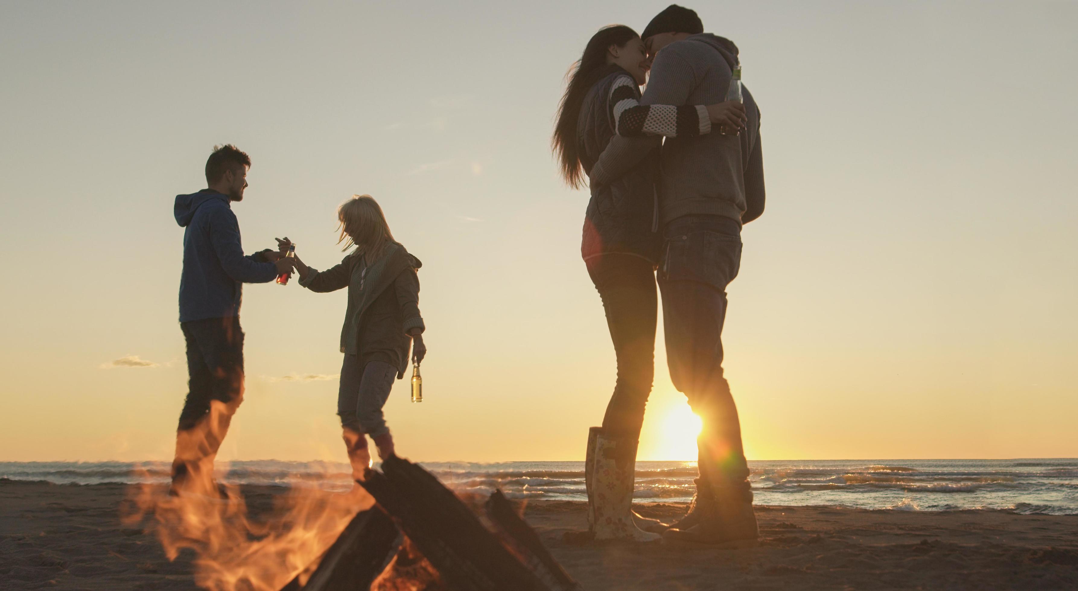 Friends having fun at beach on autumn day Stock Free