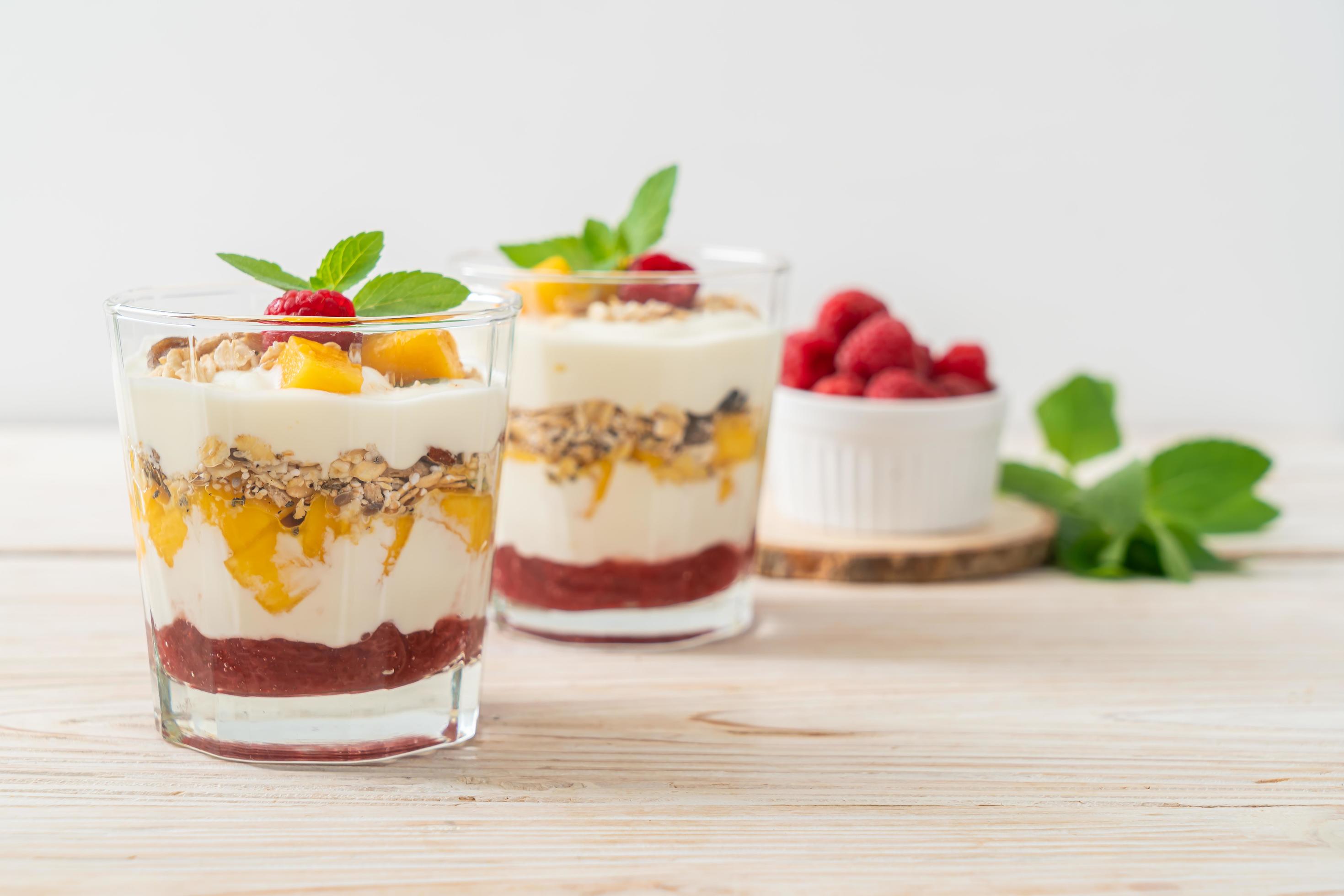 Homemade fresh mango and fresh raspberry with yogurt and granola – healthy food style Stock Free