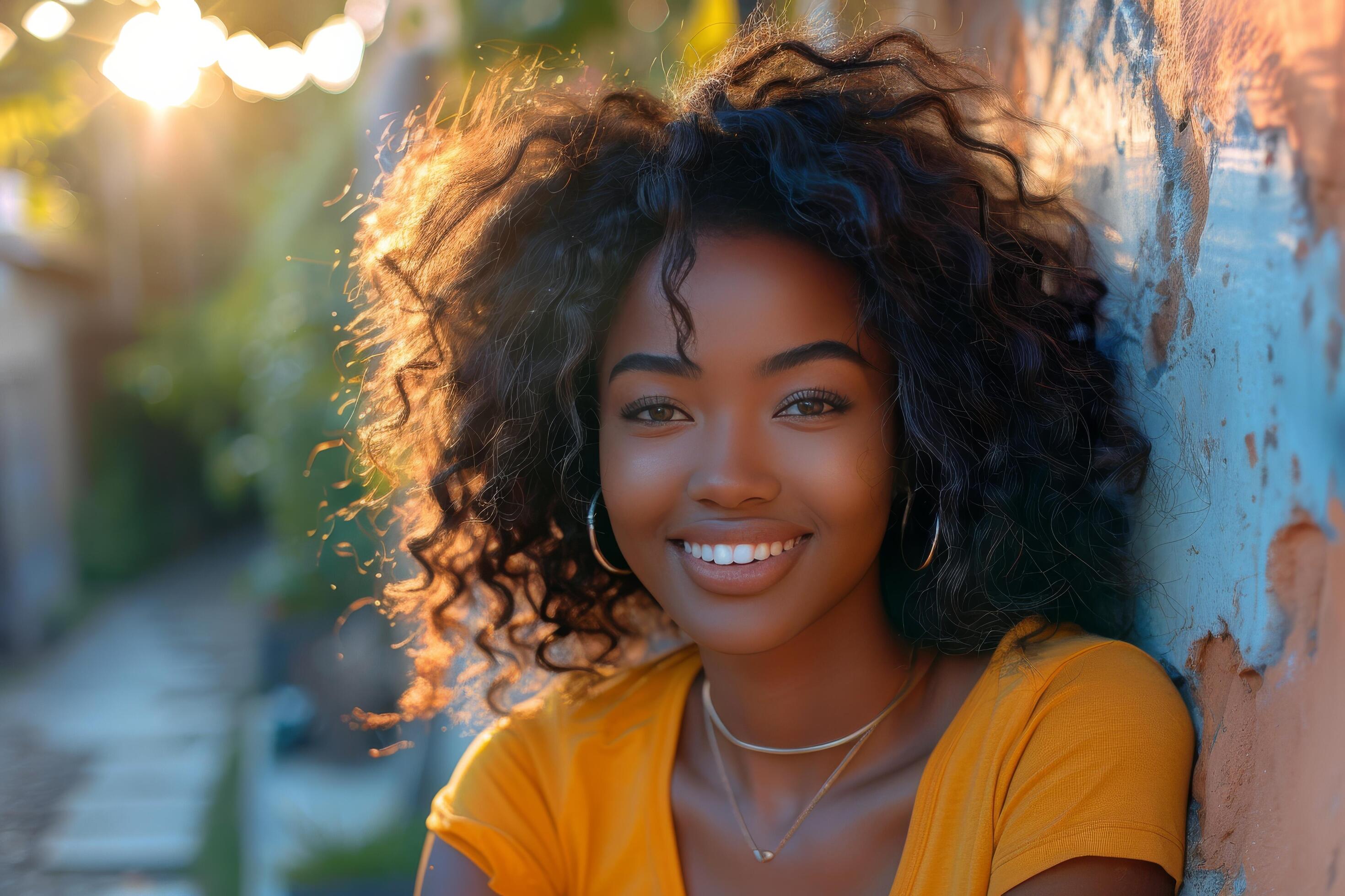 Smiling Woman With Dreadlocks in a Yellow Shirt on a Street in a City Stock Free